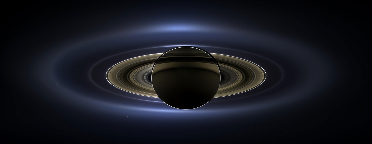 On July 19, 2013, NASA's Cassini spacecraft slipped into Saturn's shadow and photographed the planet and its rings, seven of its moons, and, in the background, the blue speck that is Earth. The image, released on obtained November 13, 2013, was painstakingly assembled from 141 mosaic-like pieces. It spans about 404,880 miles (651,591 kilometers) from one side to the other.