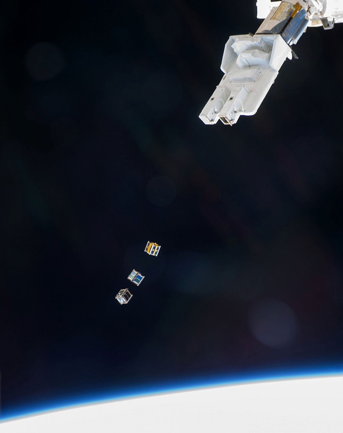 Three nanosatellites, known as Cubesats, are deployed on Nov. 19, 2013 from a Small Satellite Orbital Deployer (SSOD) attached to the a robotic arm on the International Space Station.