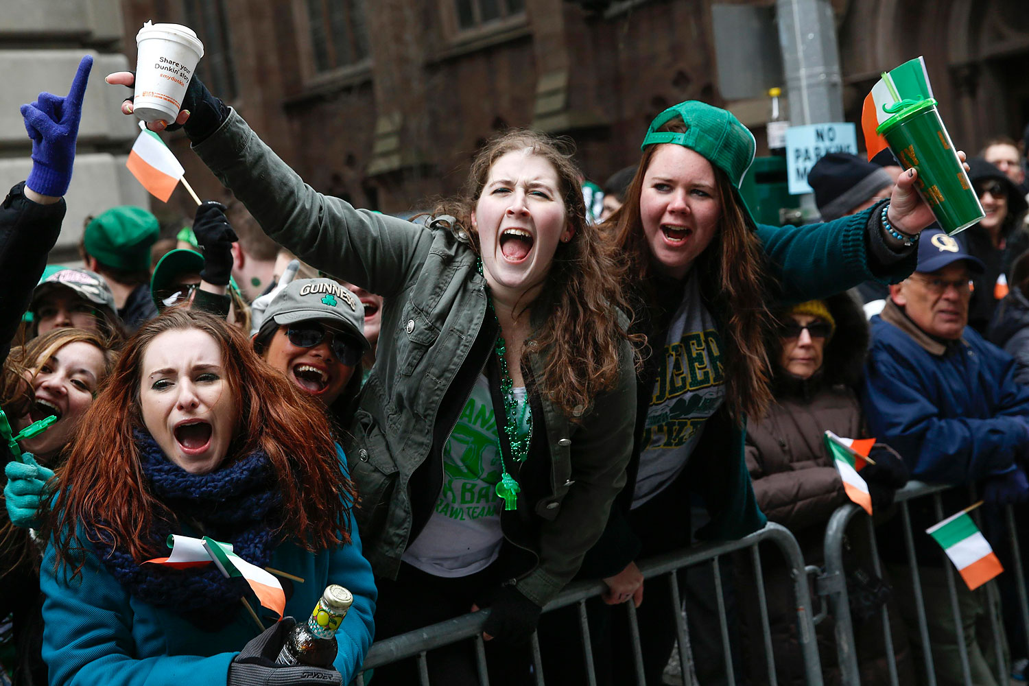 People cheer along 5th avenue during the St. Patrick's Day parade in New York, March 17, 2014.