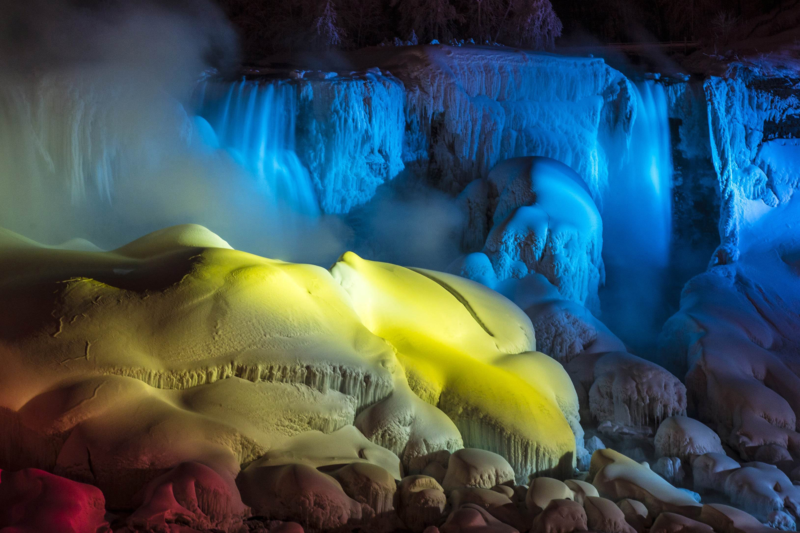 A partially frozen Niagara Falls is seen on American side lit by lights during sub freezing temperatures in Niagara Falls, Ontario, March 3, 2014.