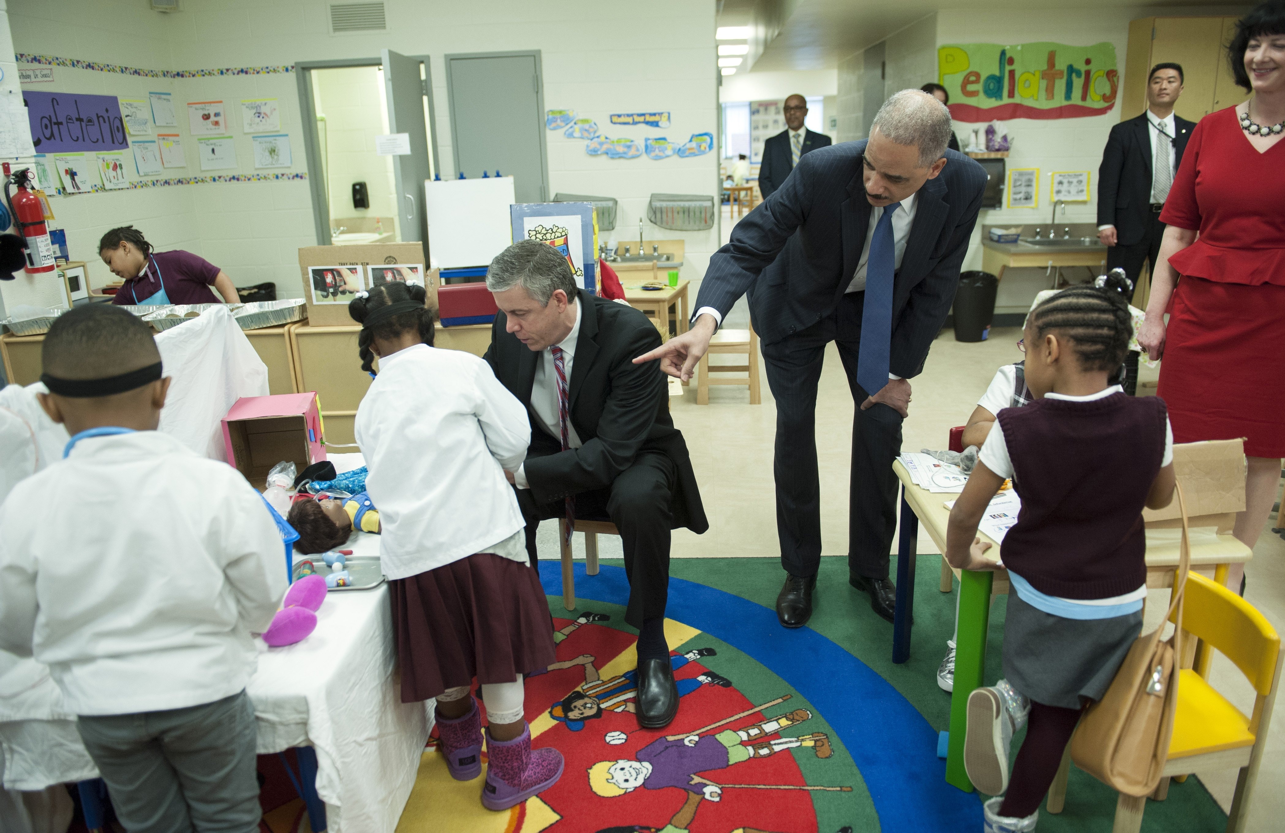 Education Secretary Arne Duncan and Attorney General Eric Holder meet with a preschool class prior to participating in a discussion on the importance of universal access to preschool at J. Ormond Wilson Elementary School in Washington, March 21, 2014. (Cliff Owen&amp;mdash;AP)
