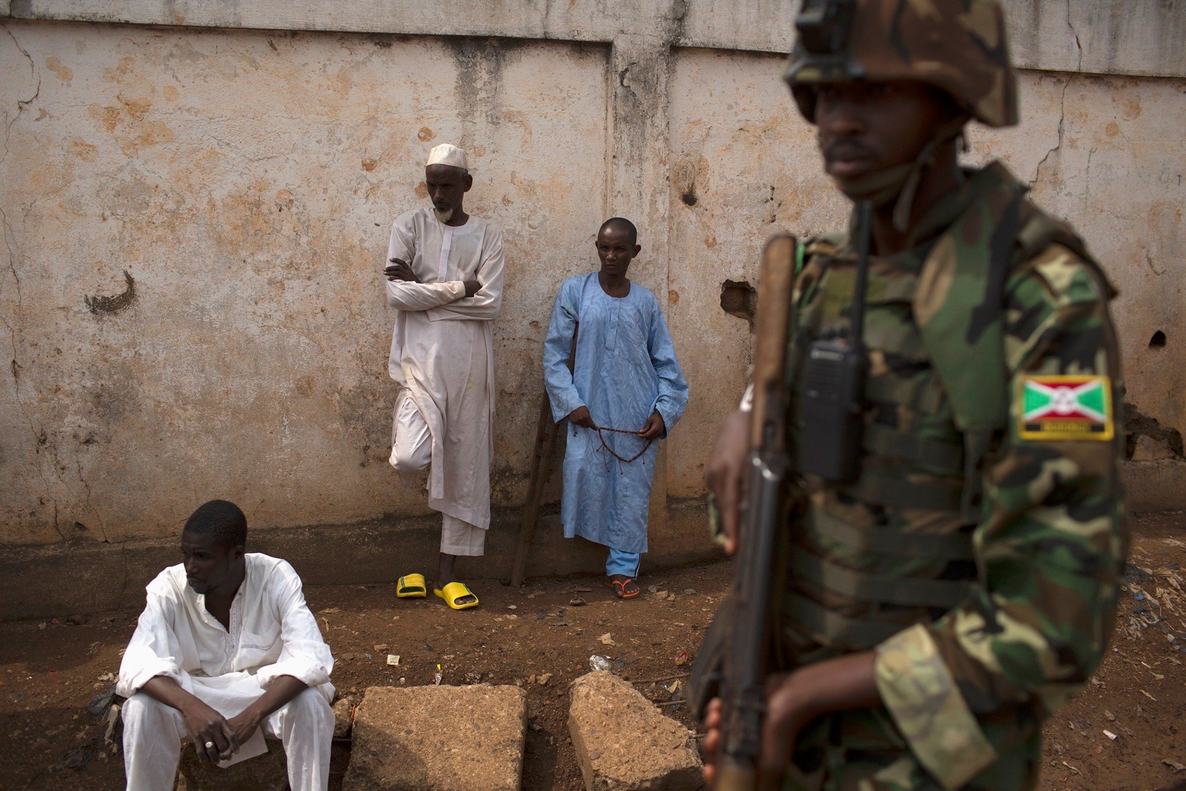 An African Union (AU) soldier stands guard outside a home at the end of a funeral of two men killed by sectarian violence in the Muslim neighbourhood of Kilometre 5 (PK5) in the capital Bangui