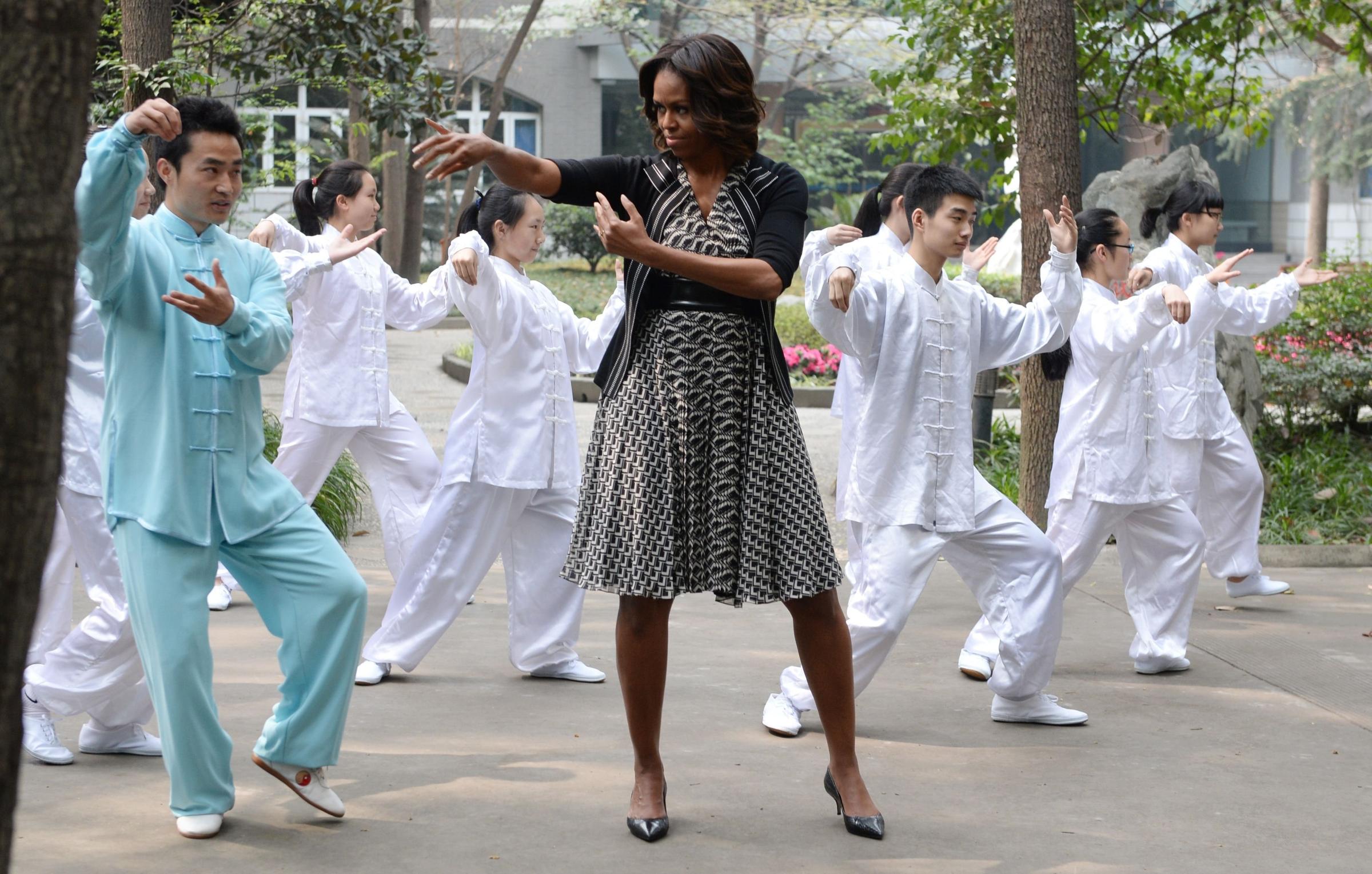 US First Lady Michelle Obama performs "tai chi" with students from the Chengdu No7 High School in Chengdu in China's southwest Sichuan province on March 25, 2014.