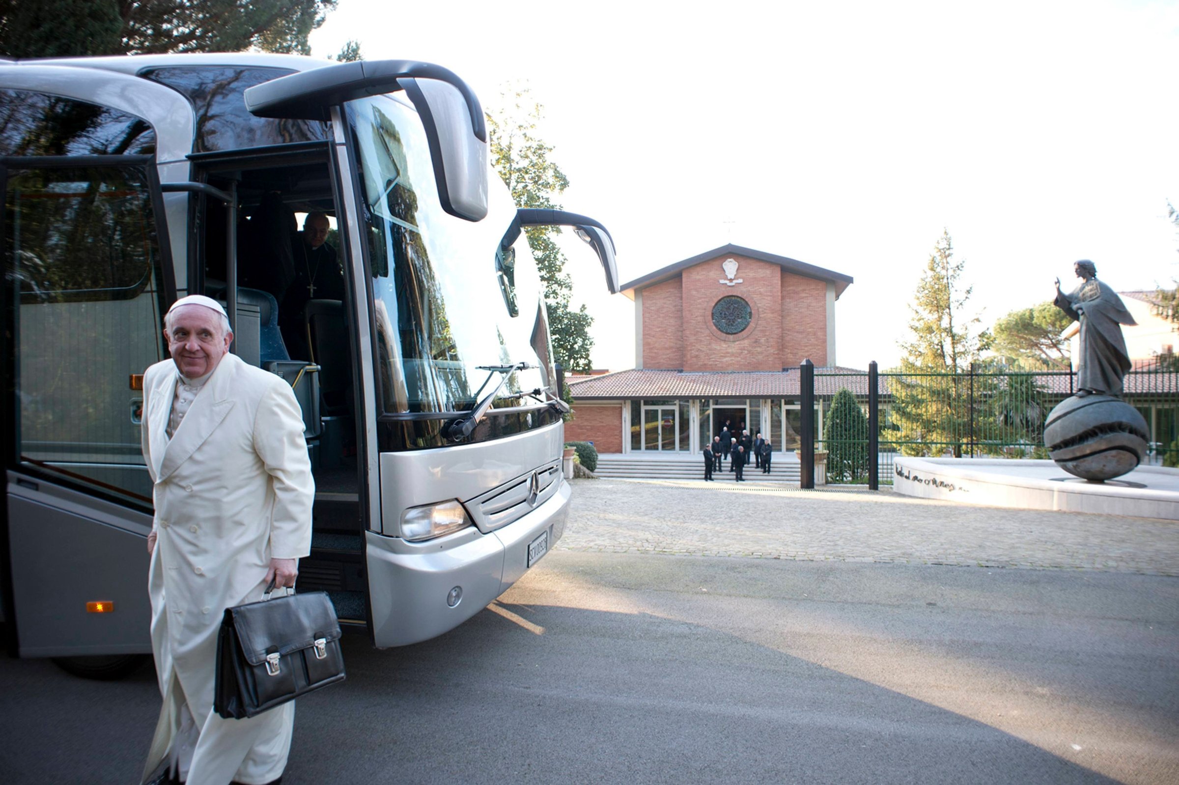 Pope Francis alights from a bus with other cardinals and bishops for a retreat in Ariccia