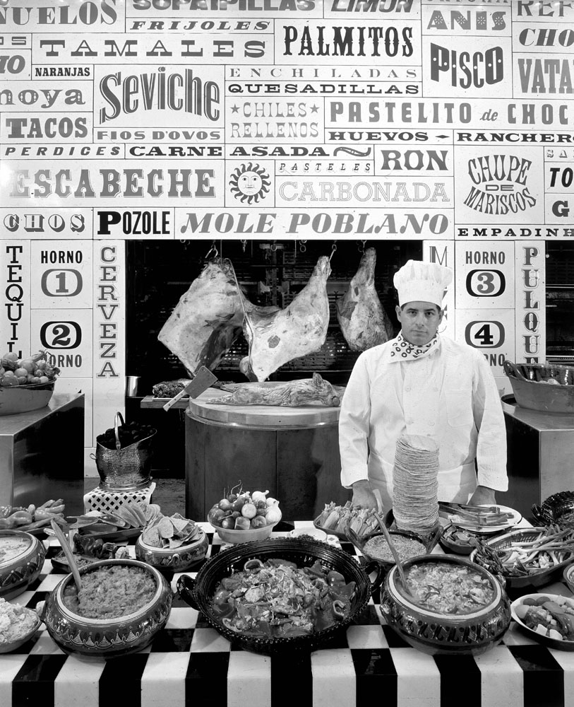 Servers presented a cornucopia of dishes and lavish cuts of meat to guests in front of a mod, typographically embellished wall.