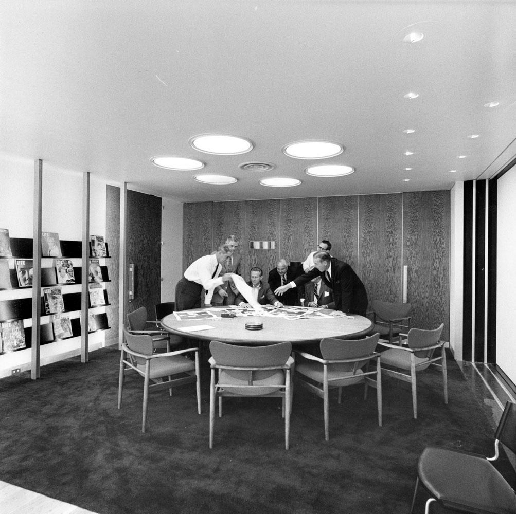 Here in this conference room, a couple of LIFE magazine staffers discuss the pages in layouts.