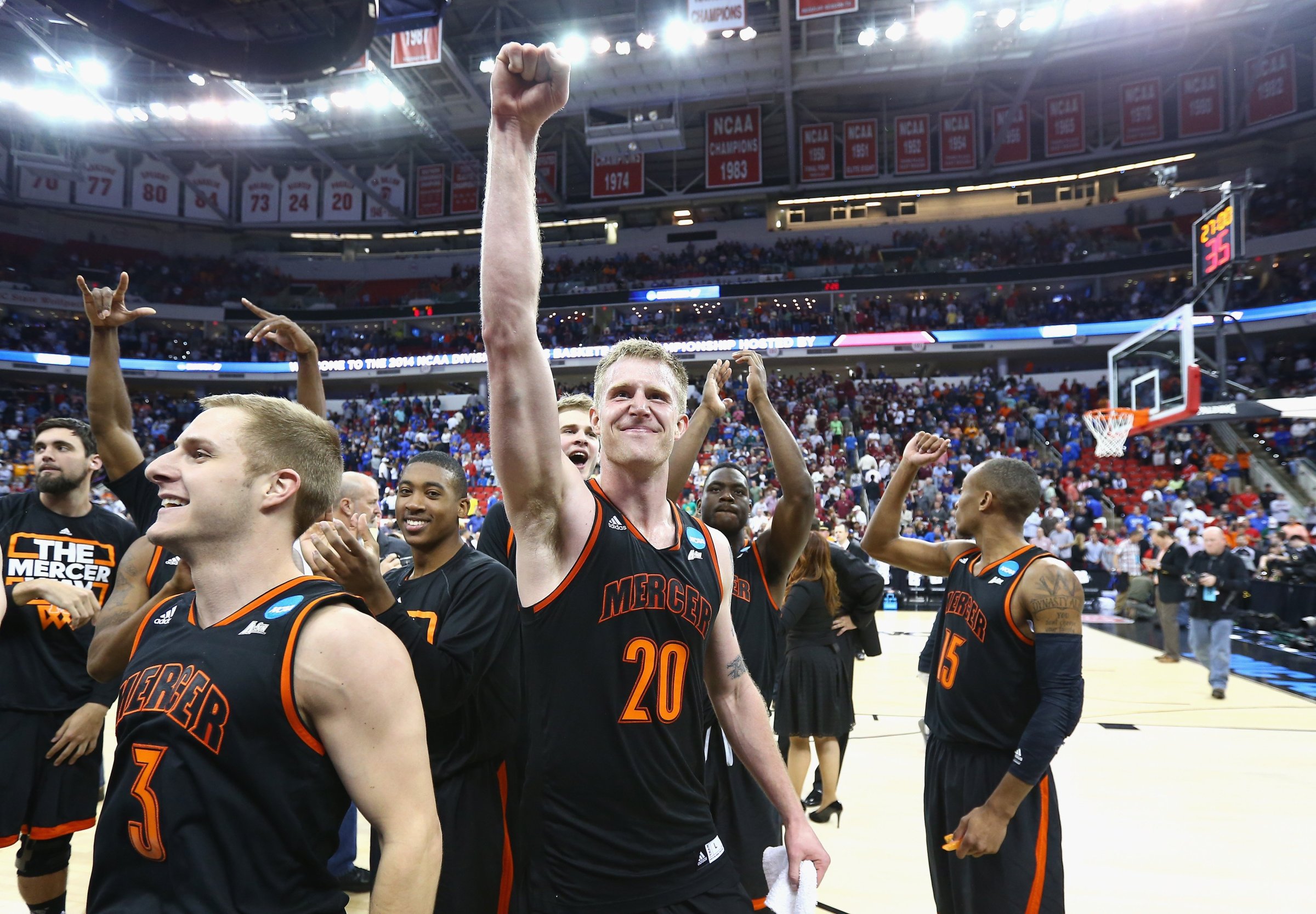 Jakob Gollon of the Mercer Bears celebrates with teammates after defeating the Duke Blue Devils 78-71