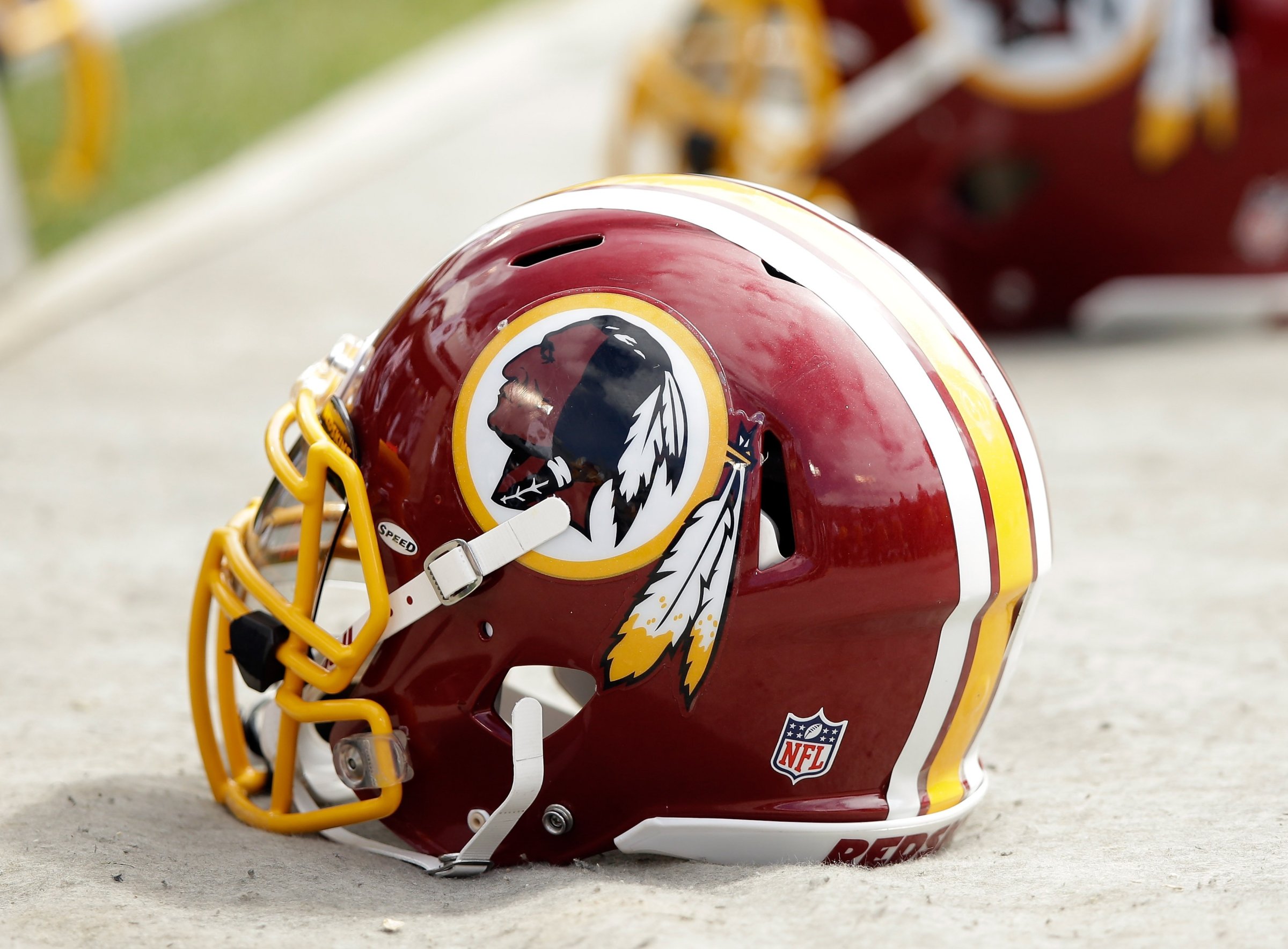 Washington Redskins helmets lay on the ground during a game against the Oakland Raiders