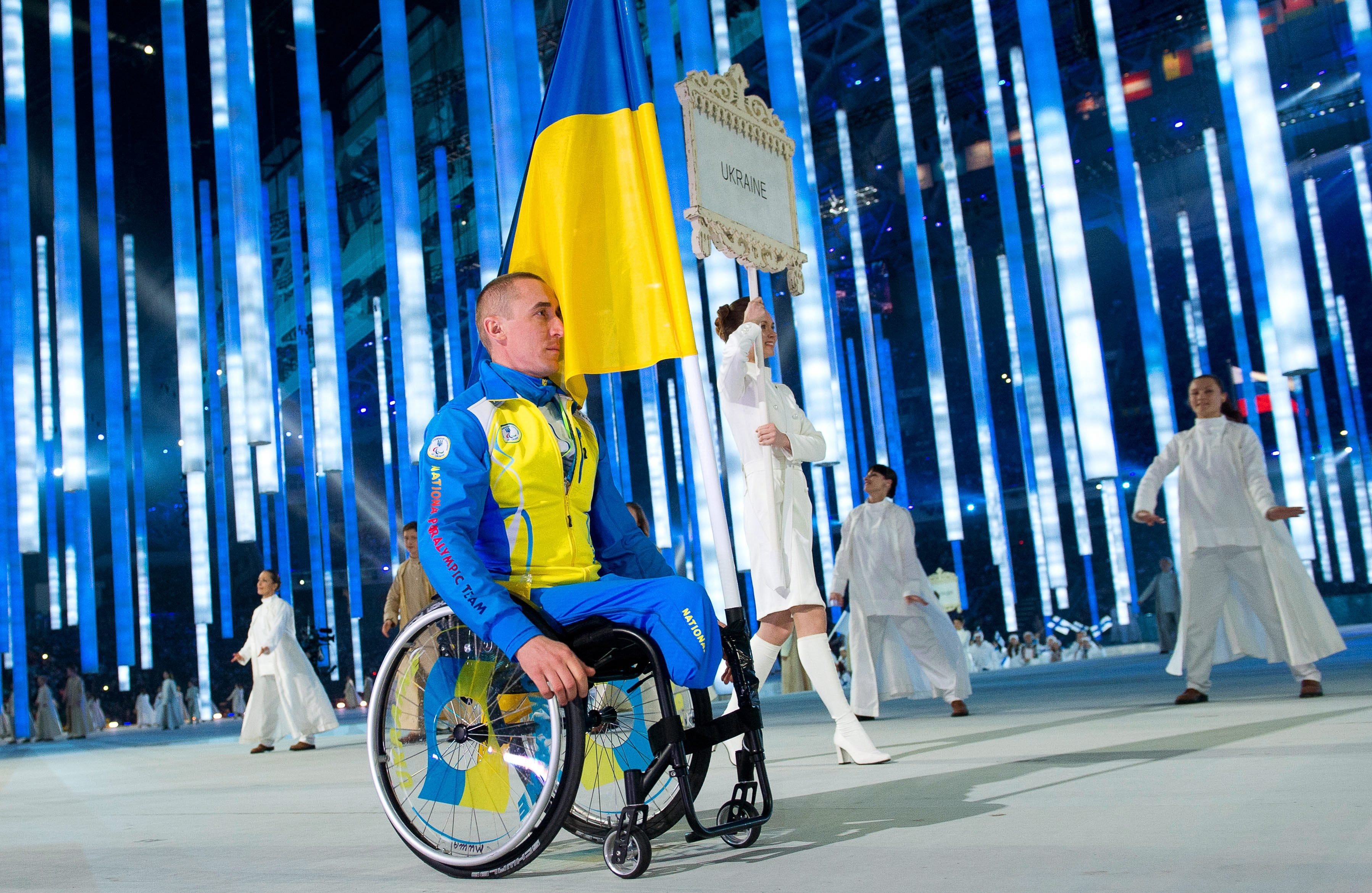 Flag bearer Mykhaylo Tkachenko of Ukraine attends the Opening Ceremony of the Sochi 2014 Winter Paralympic Games at Fisht Olympic Stadium in Sochi, Russia, March 07 2014. (Julian Stratenschulte—EPA)