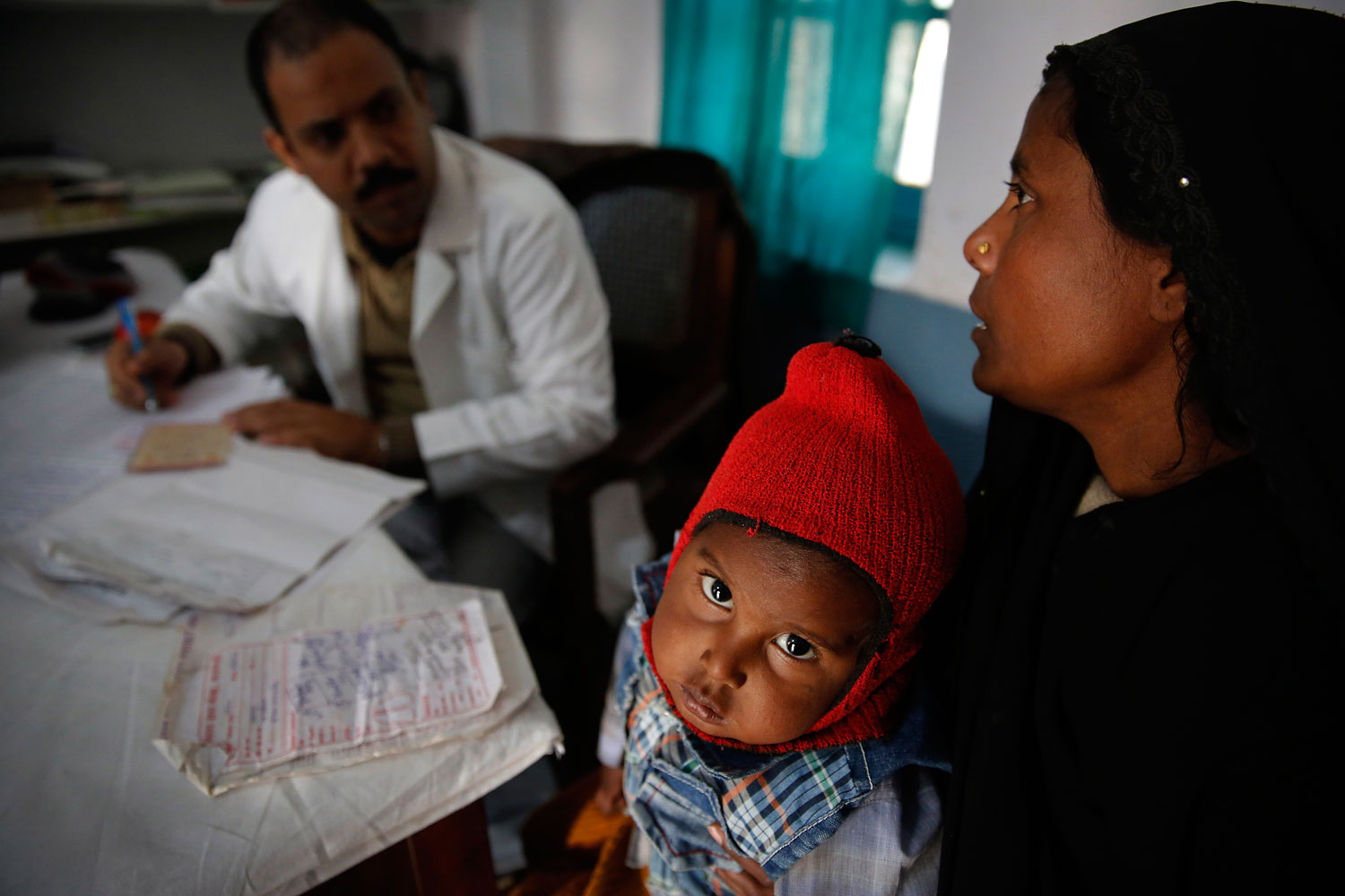 A doctor attends to Anwar, 4, infected with tuberculosis at the Kashi Vidyapith block hospital, Kotawa near Varanasi, India, Feb. 1, 2014. (Rajesh Kumar Singh—AP)