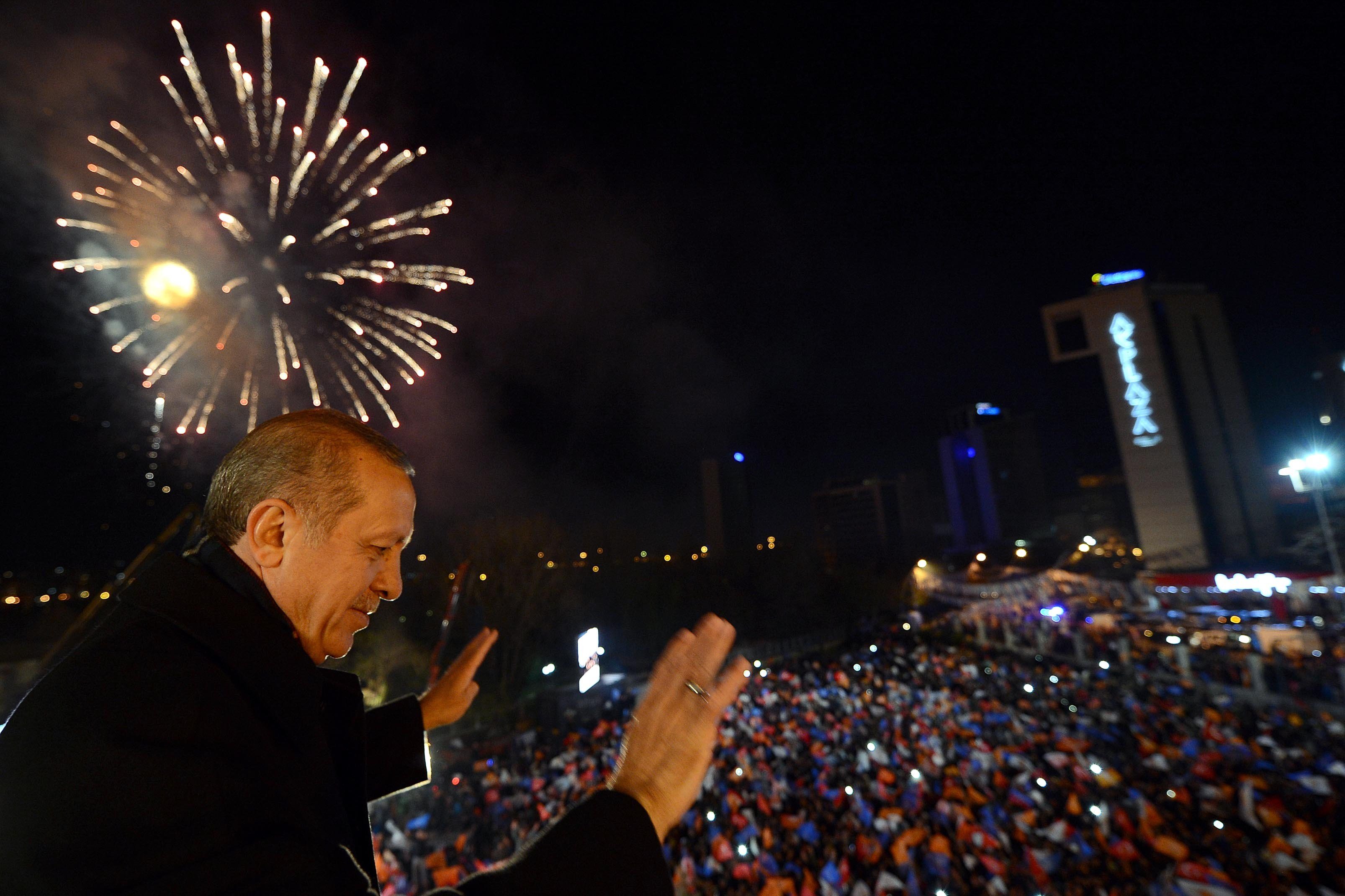 Turkey's Prime Minister Tayyip Erdogan greets his supporters in Ankara on March 30, 2014. 