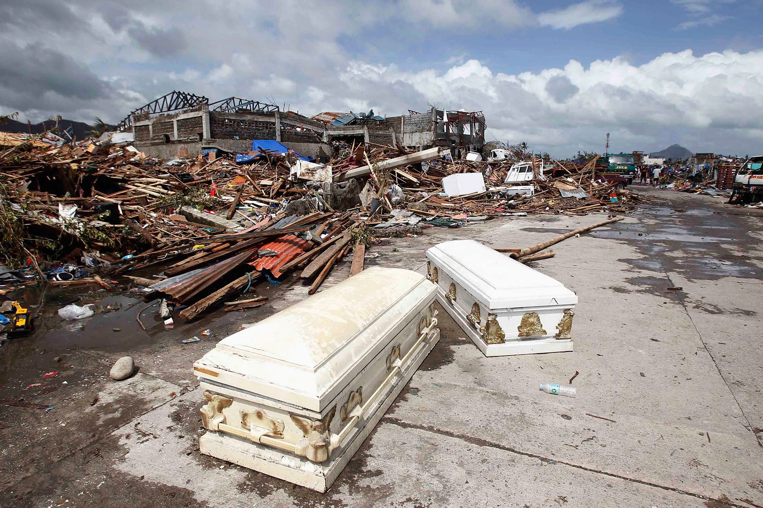 Empty coffins lie on a street near ruined houses on Nov. 10, 2013, after Supertyphoon Haiyan battered the city of Tacloban, in central Philippines