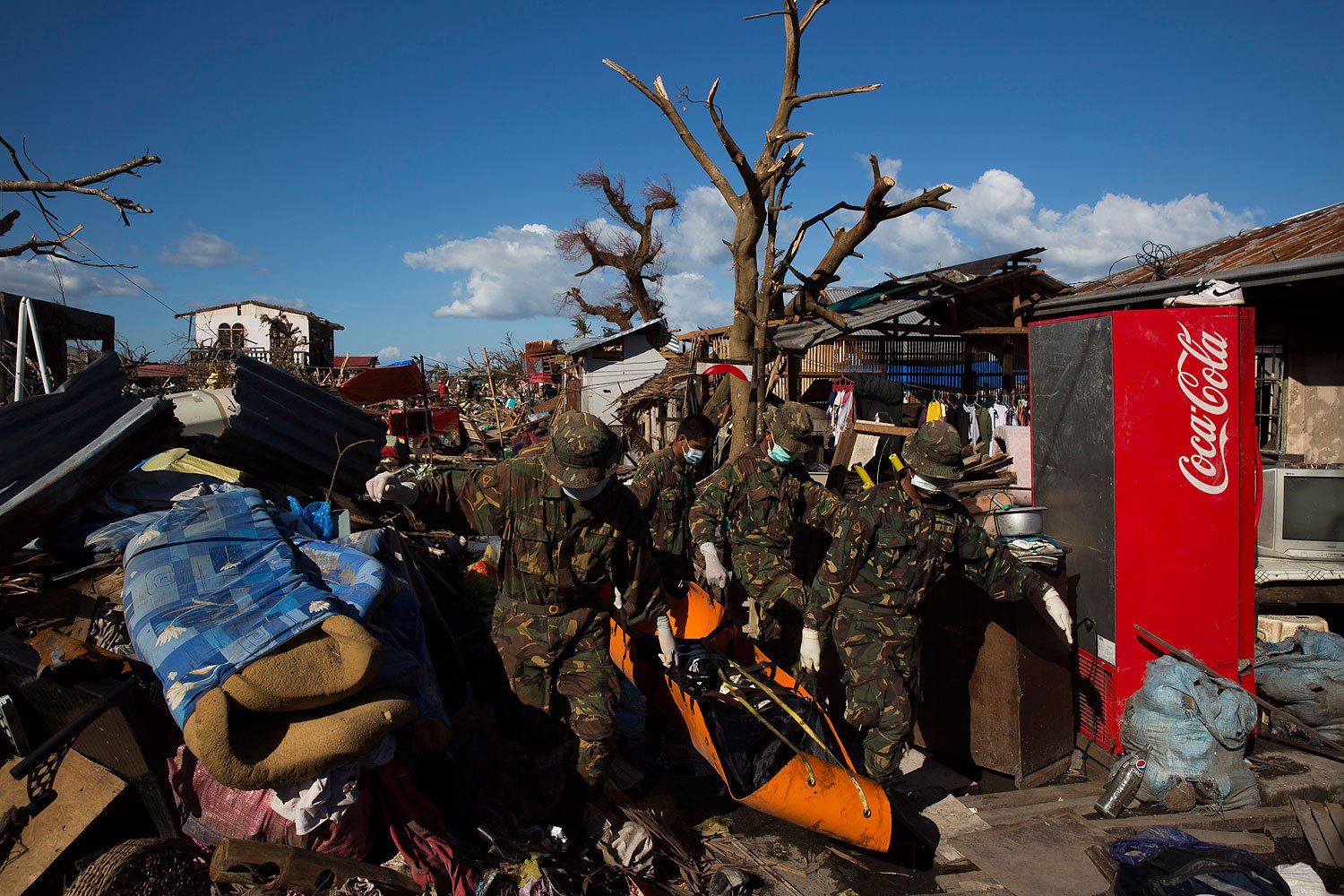 Soldiers and search and rescue teams collect bodies of people killed by Typhoon Haiyan in Tanuan, Philippines on November 15, 2013.