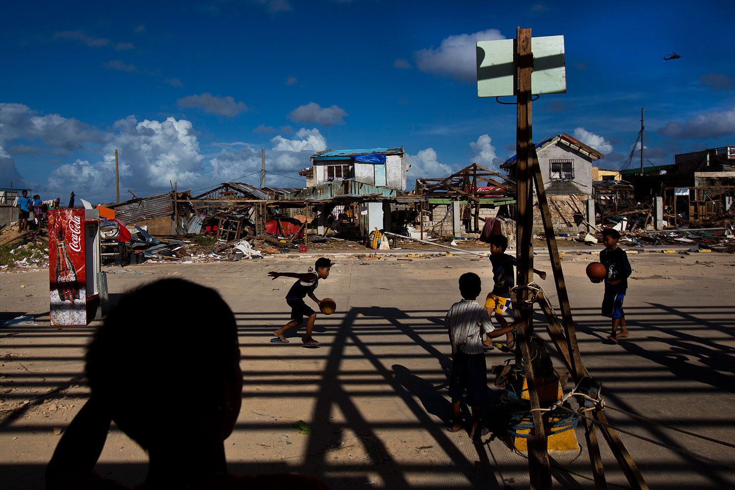 Typhoon Haiyan survivors play basketball at the destroyed port in the town of Guiuan, Philippines on November 15, 2013.