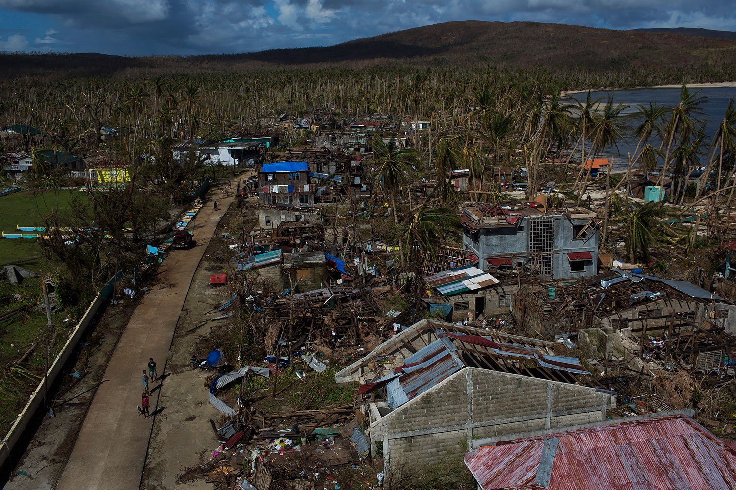 People from a remote island that was cut off by Haiyan Typhoon walk on the street in the street in Homonhon Island, Philippines on November 14, 2013.