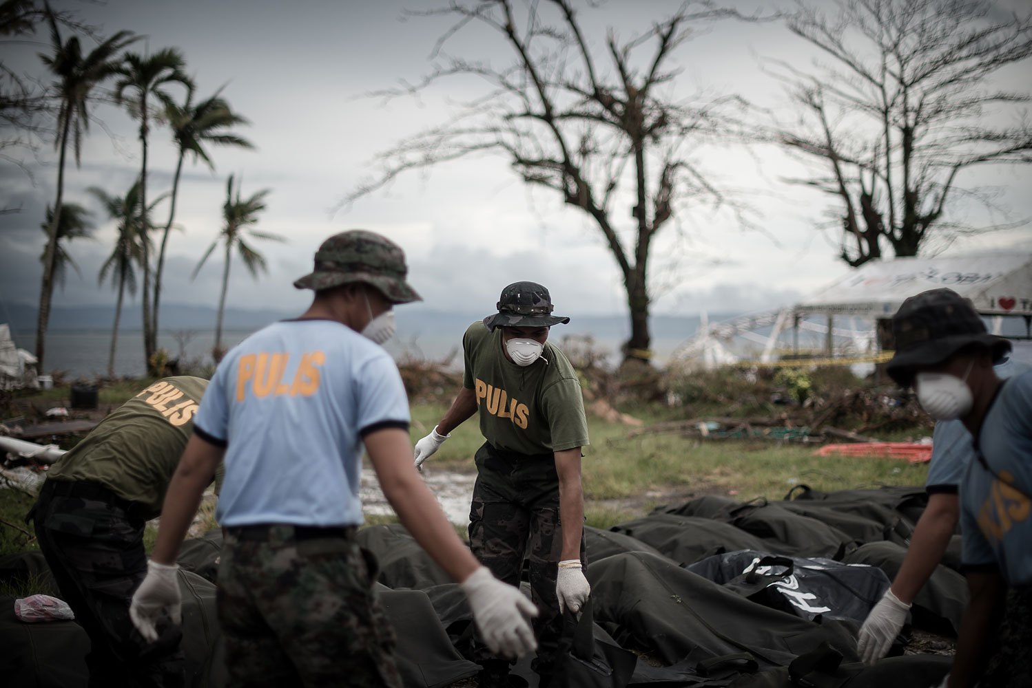 Dead bodies are unloaded at a makeshift morgue in Tacloban, on the eastern island of Leyte on November 12, 2013 after Super Typhoon Haiyan swept over the Philippines.