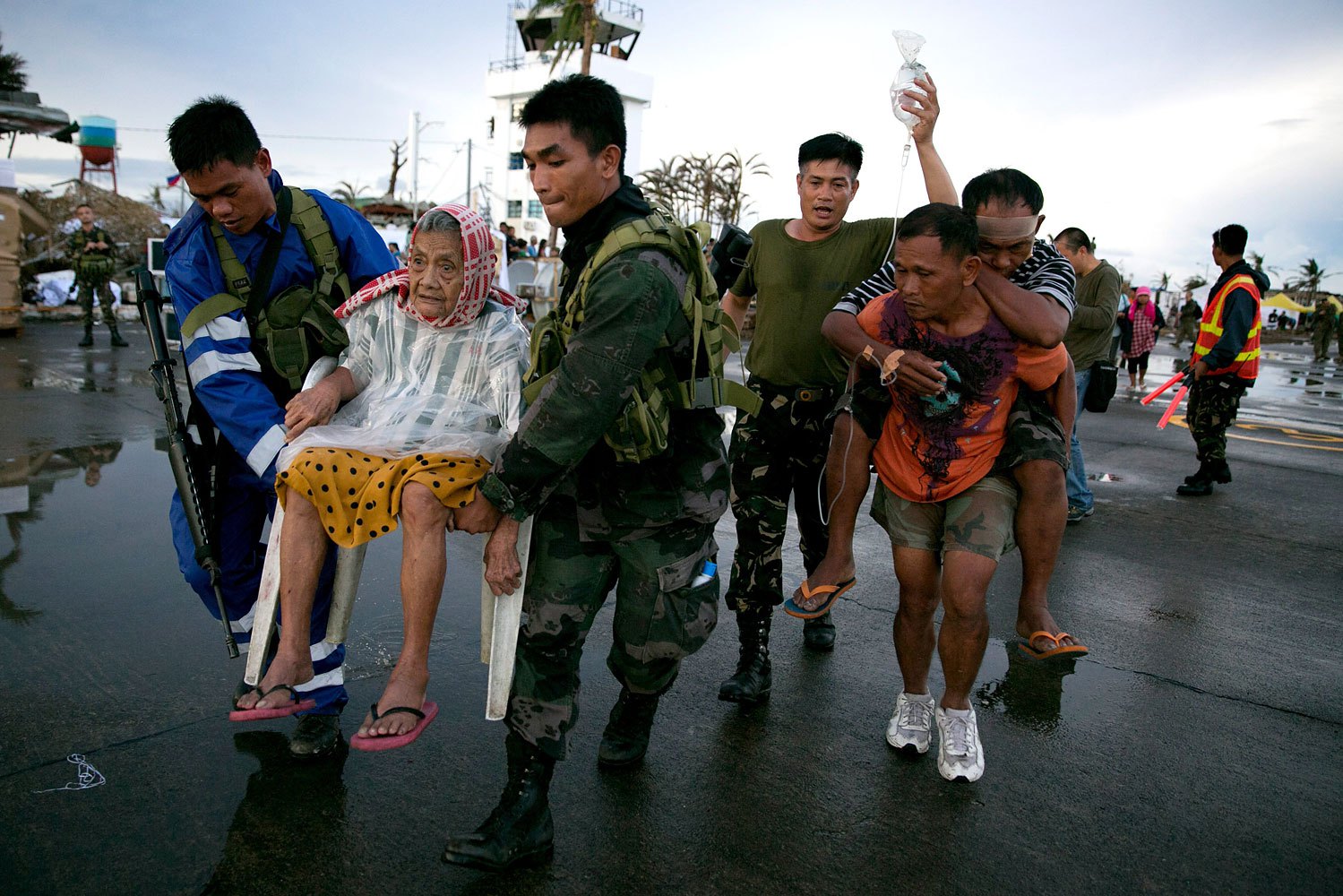 An elderly lady and an injured man are carried to a waiting C130 aircraft during the evacuation of hundreds of survivors of Typhoon Haiyan on November 12, 2013 in Tacloban, Philippines.