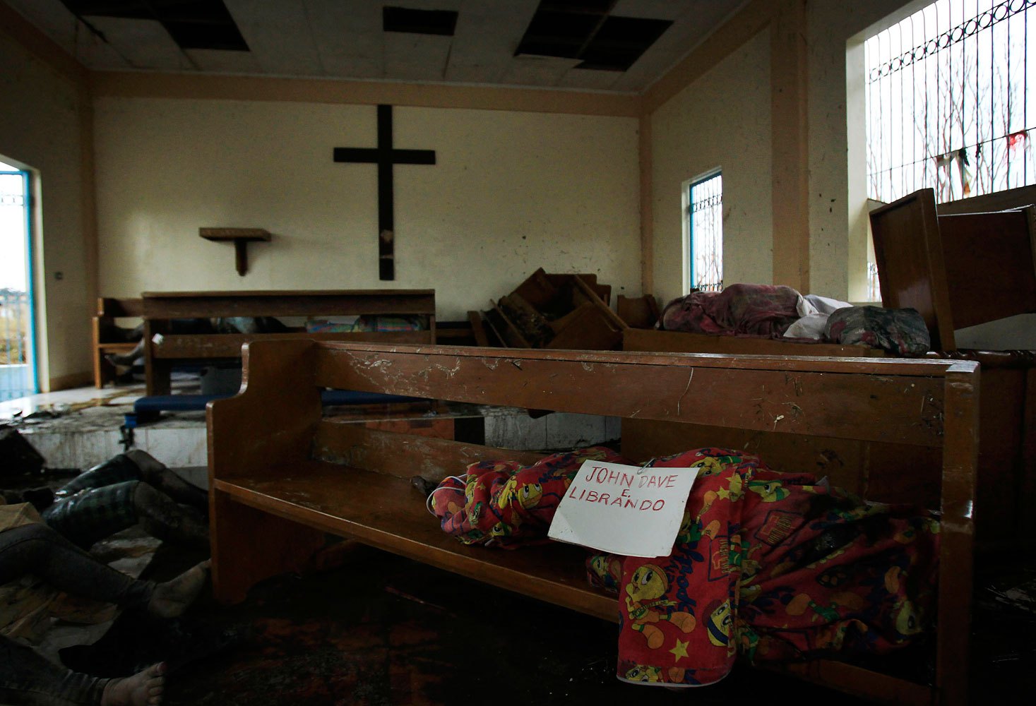 A body wrapped in cloth labeled only with a name is left on a pew at St. Michael The Archangel Chapel in Tacloban, central Philippines, November 12, 2013.