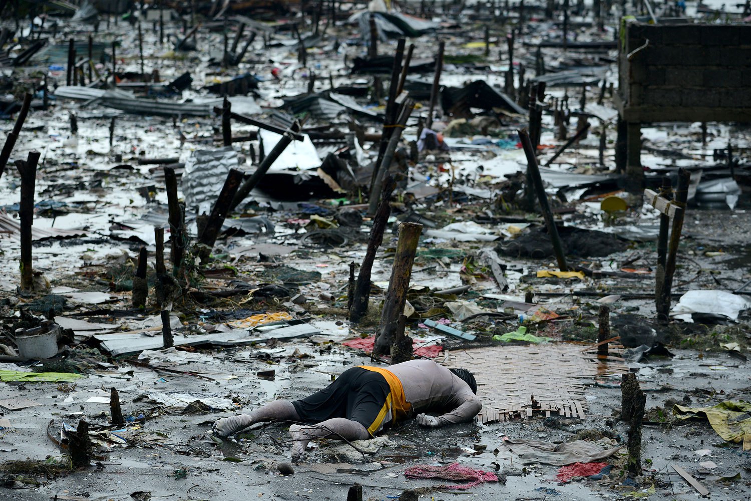 The body of a dead man is seen in Tacloban, in Leyte province, on Nov. 10, 2013, after Supertyphoon Haiyan swept over the Philippines