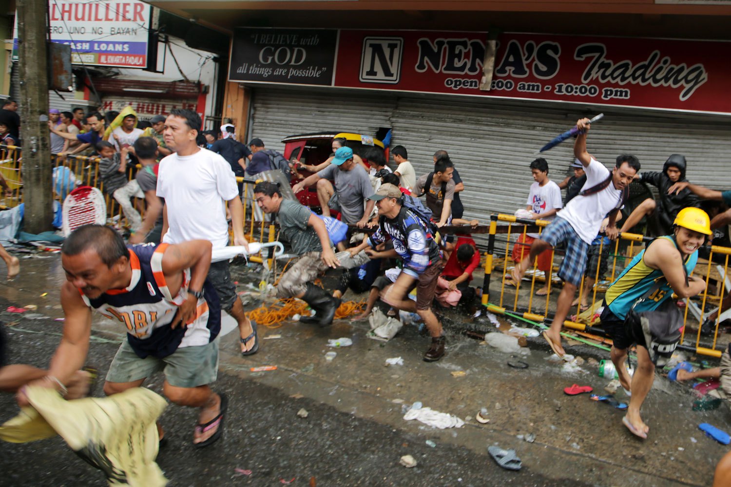 Filipinos rush in front of a store in the super typhoon devastated city of Tacloban, Leyte province, Philippines, November 10, 2013.