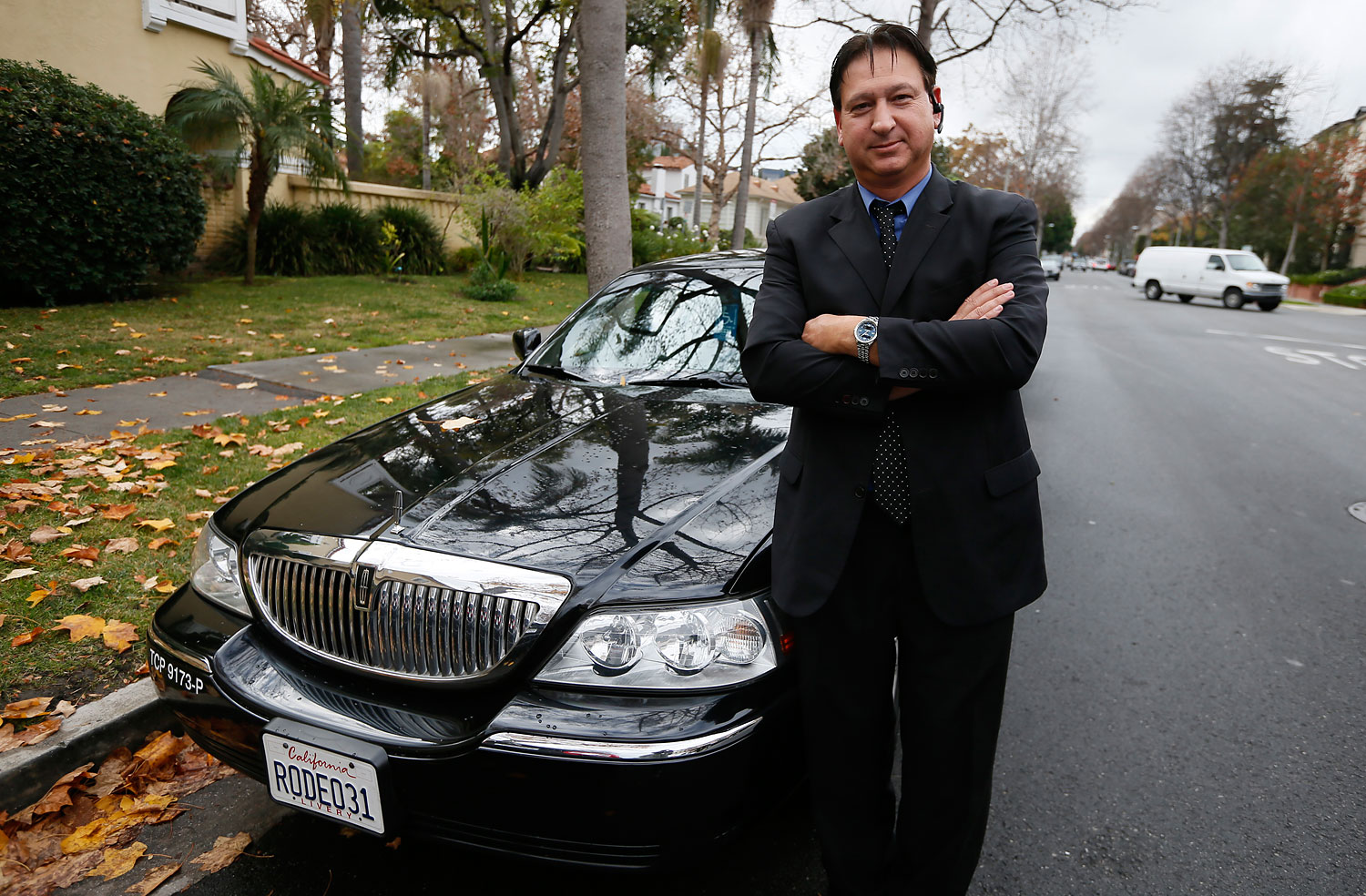 Uber driver Shuki Zanna poses in front of his limousine in Beverly Hills, California, in 2013. (Lucy Nicholson—Reuters)