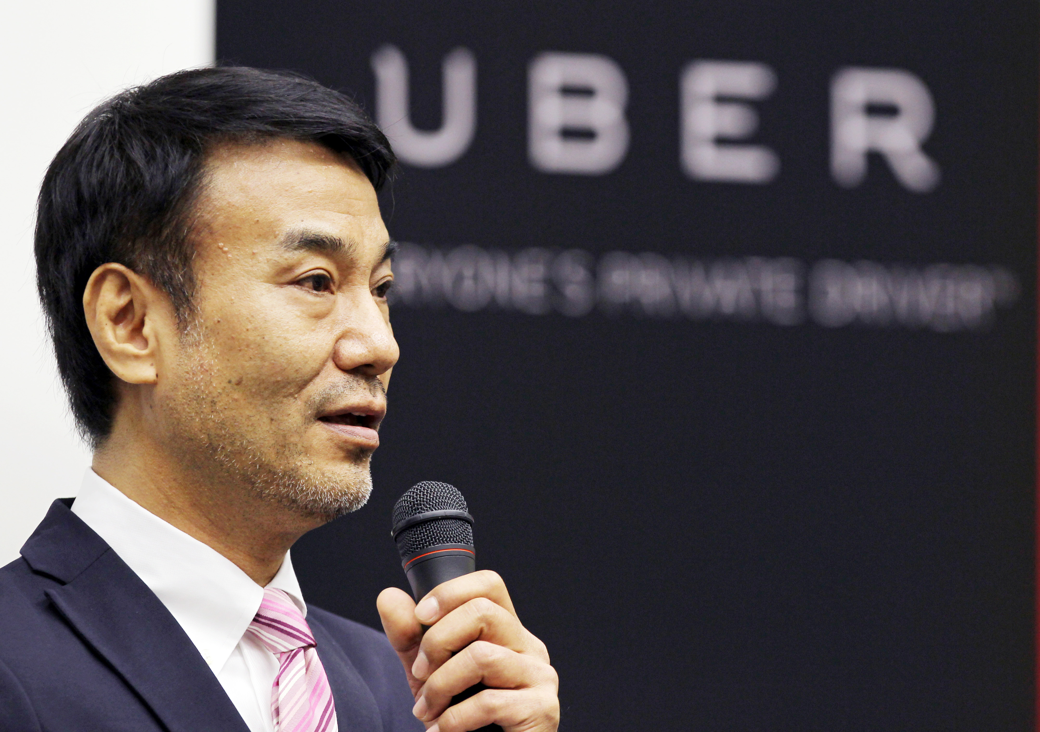 Takeji "Tak" Shiohama, president of Uber Japan Co., speaks at a news conference in Tokyo, on March 3, 2014. (Junko Kimura-Matsumoto—Bloomberg/Getty Images)