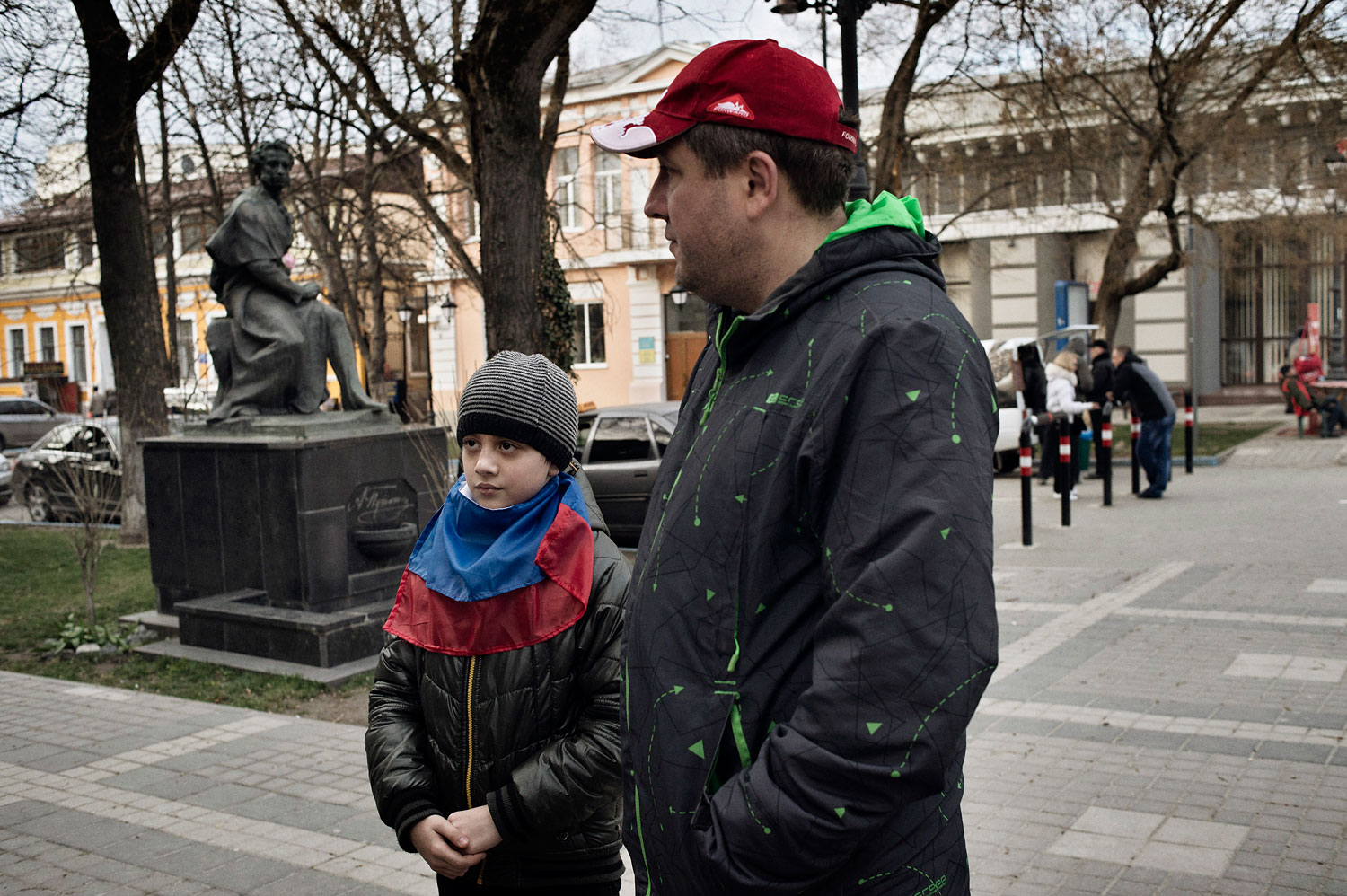 Ivan Drobkov, an ethnic Russian native of Crimea, walks near the regional parliament with his 9-year-old son Bogdan on March 17, 2014.