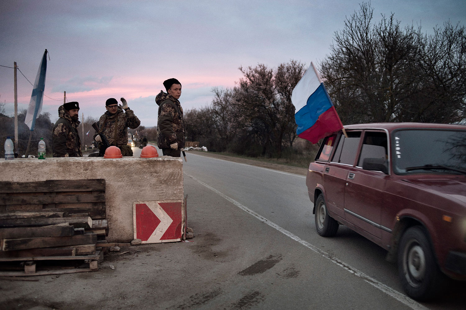 Members of the Cossack paramilitary force in Crimea guard a checkpoint on the highway leading to the city of Sevastopol, home of Russia's Black Sea naval fleet, on March 16, 2014.
