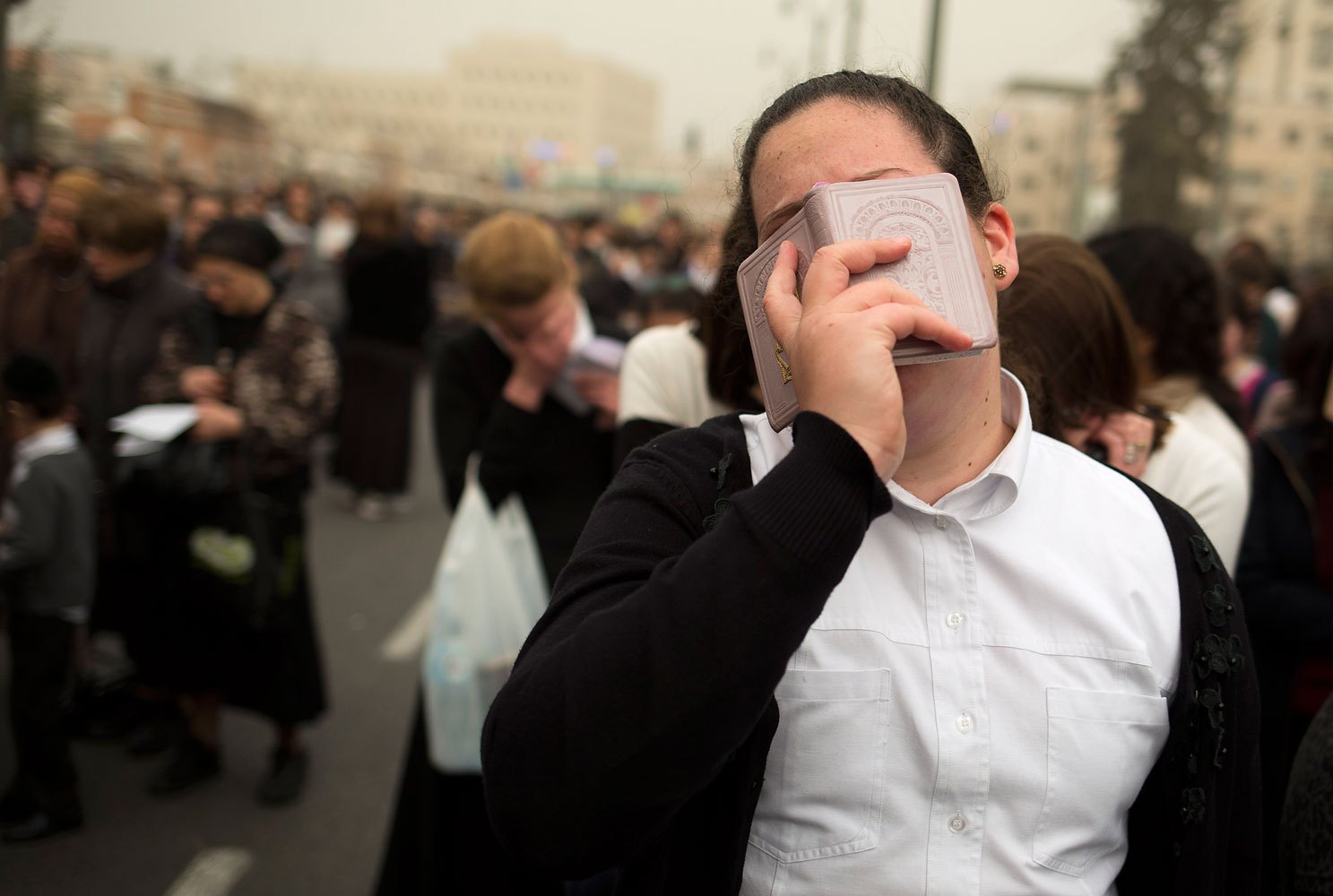 An ultra-Orthodox woman prays during a mass protest in Jerusalem, March 2, 2014.