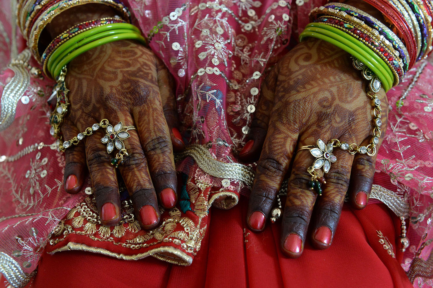 Mar. 3, 2014. An Indian bride in traditional attire sits as she takes part in a mass marriage ceremony at a local temple in the old quarters of New Delhi.