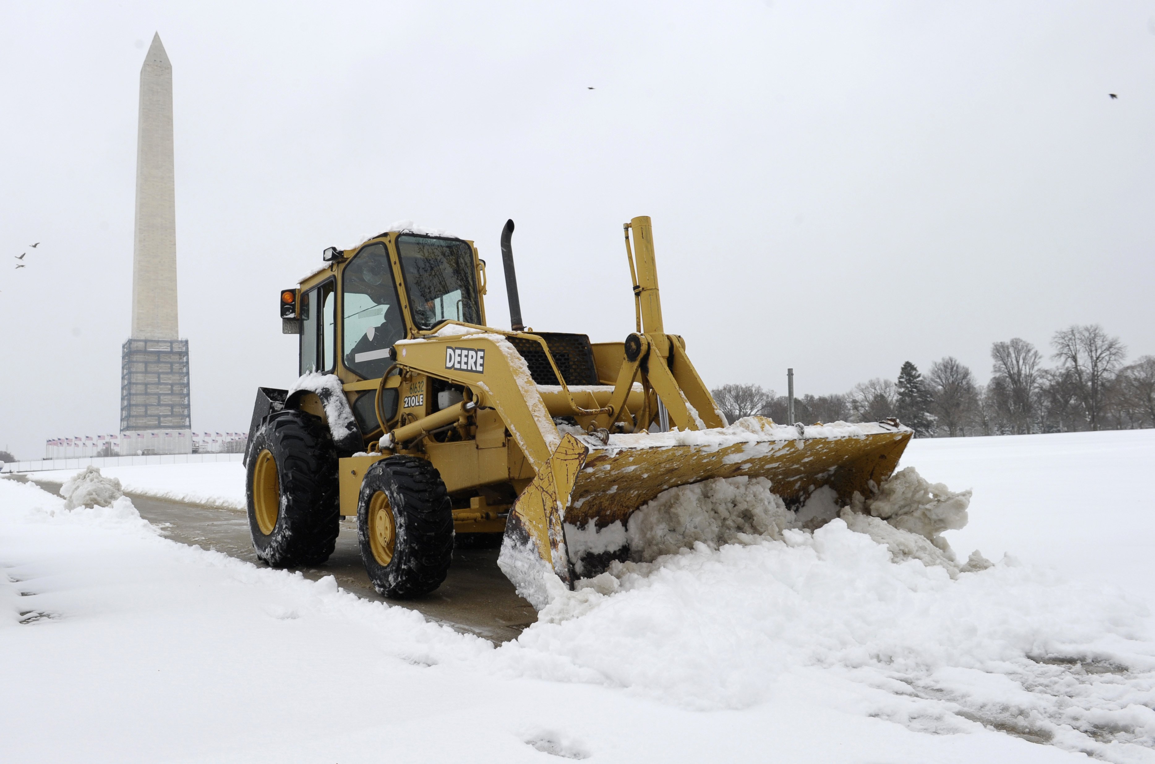 A snow plow clears the area around the Washington Monument in Washington, D.C. on March 17, 2014. (Susan Walsh—AP)