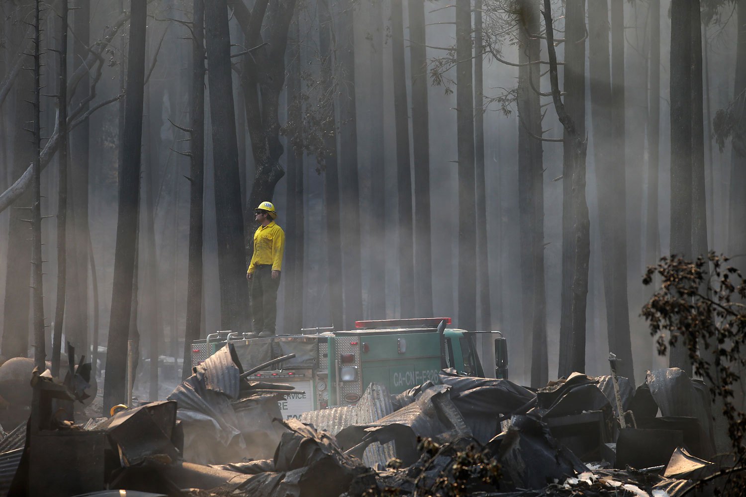 A firefighter stands on top of a fire truck at a campground destroyed by the Rim Fire near Yosemite National Park, Calif., Aug. 26, 2013. The fire burned nearly 371 square miles and was one of the largest-ever in the state.