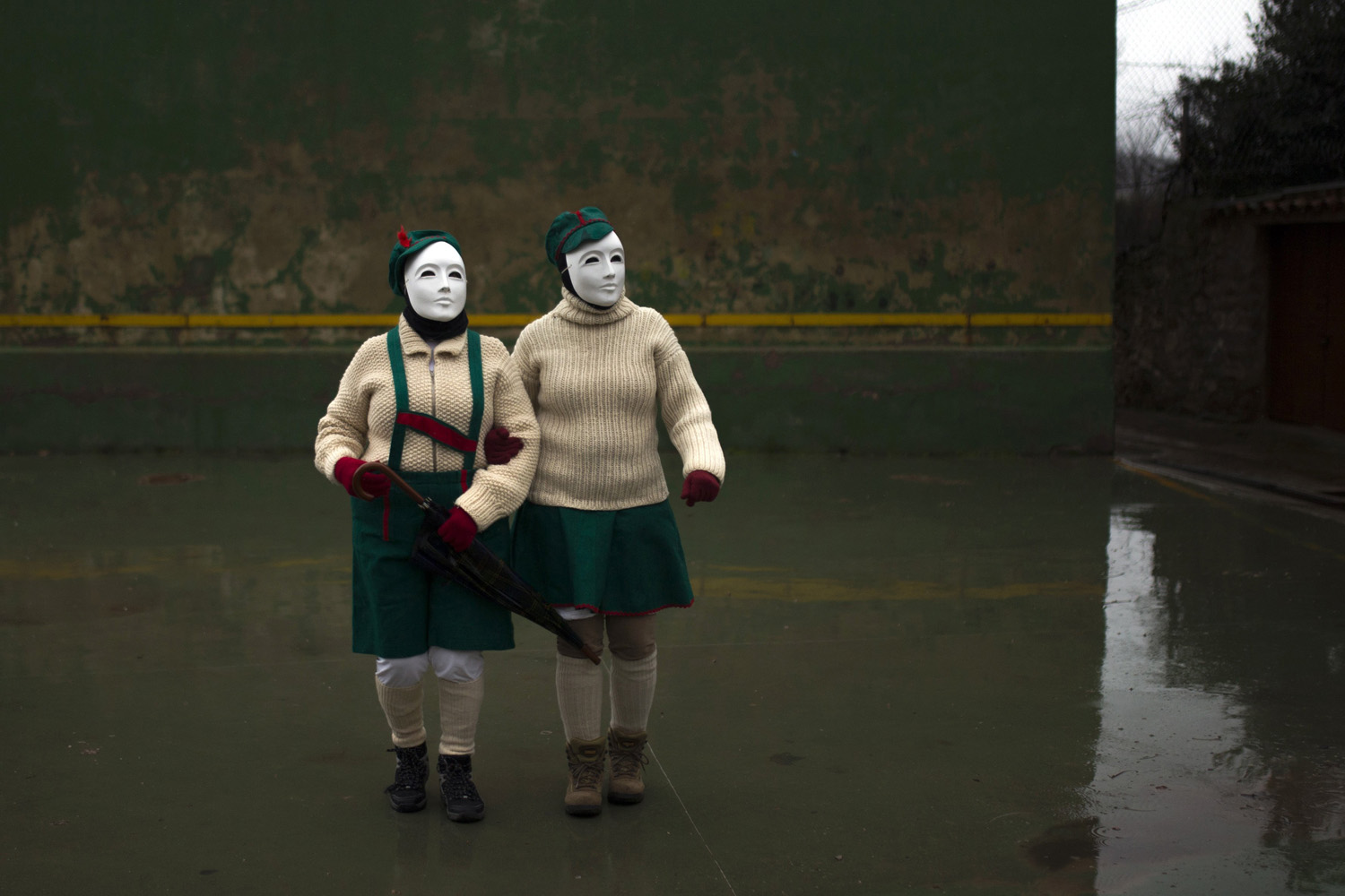 Mar. 1, 2014. People wearing masks walk around a square to participate in a traditional carnival celebration in the small village of Luzon Spain.