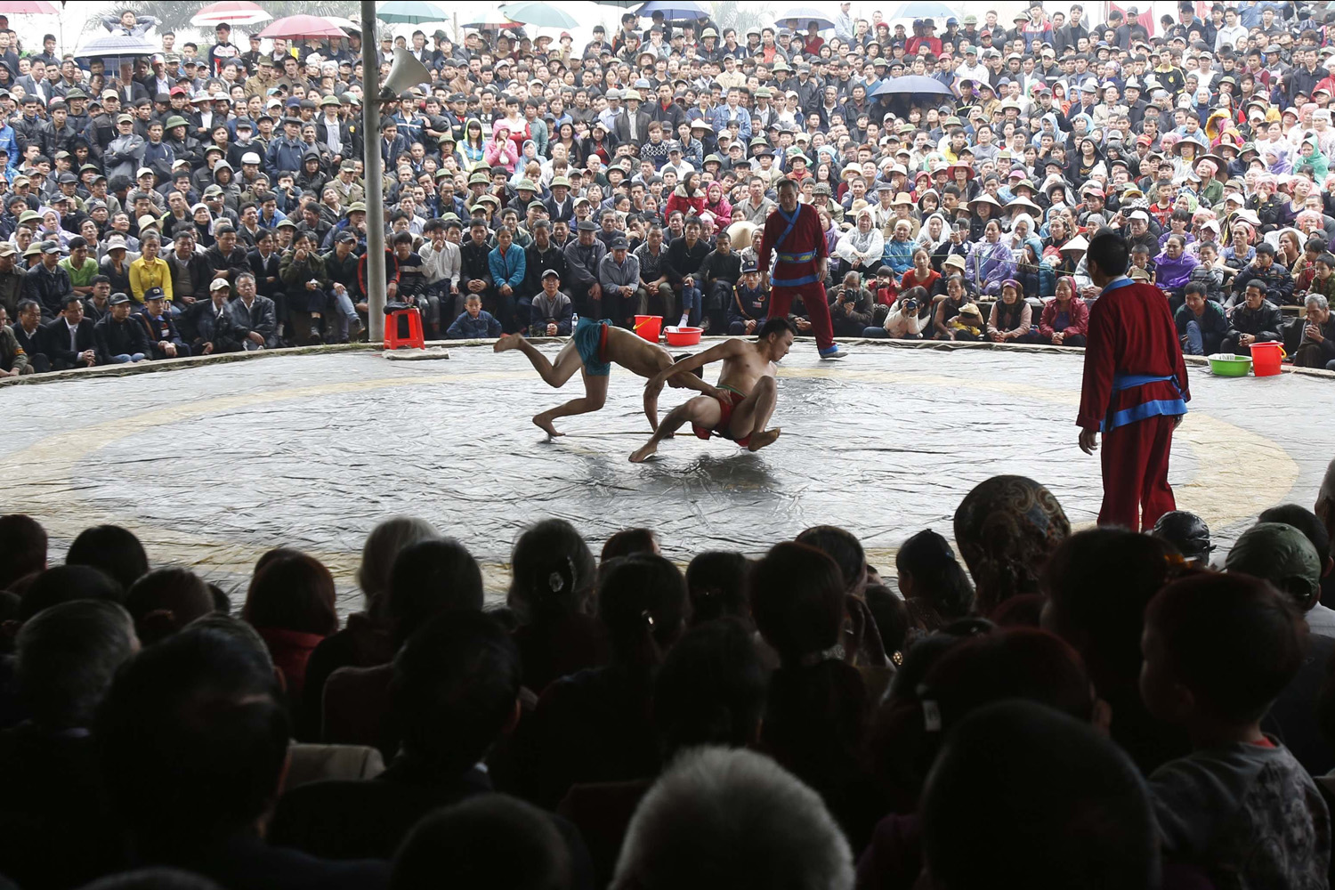 Villagers watch a wrestling match during Chua Nanh festival in Ninh Hiep village, outside Hanoi