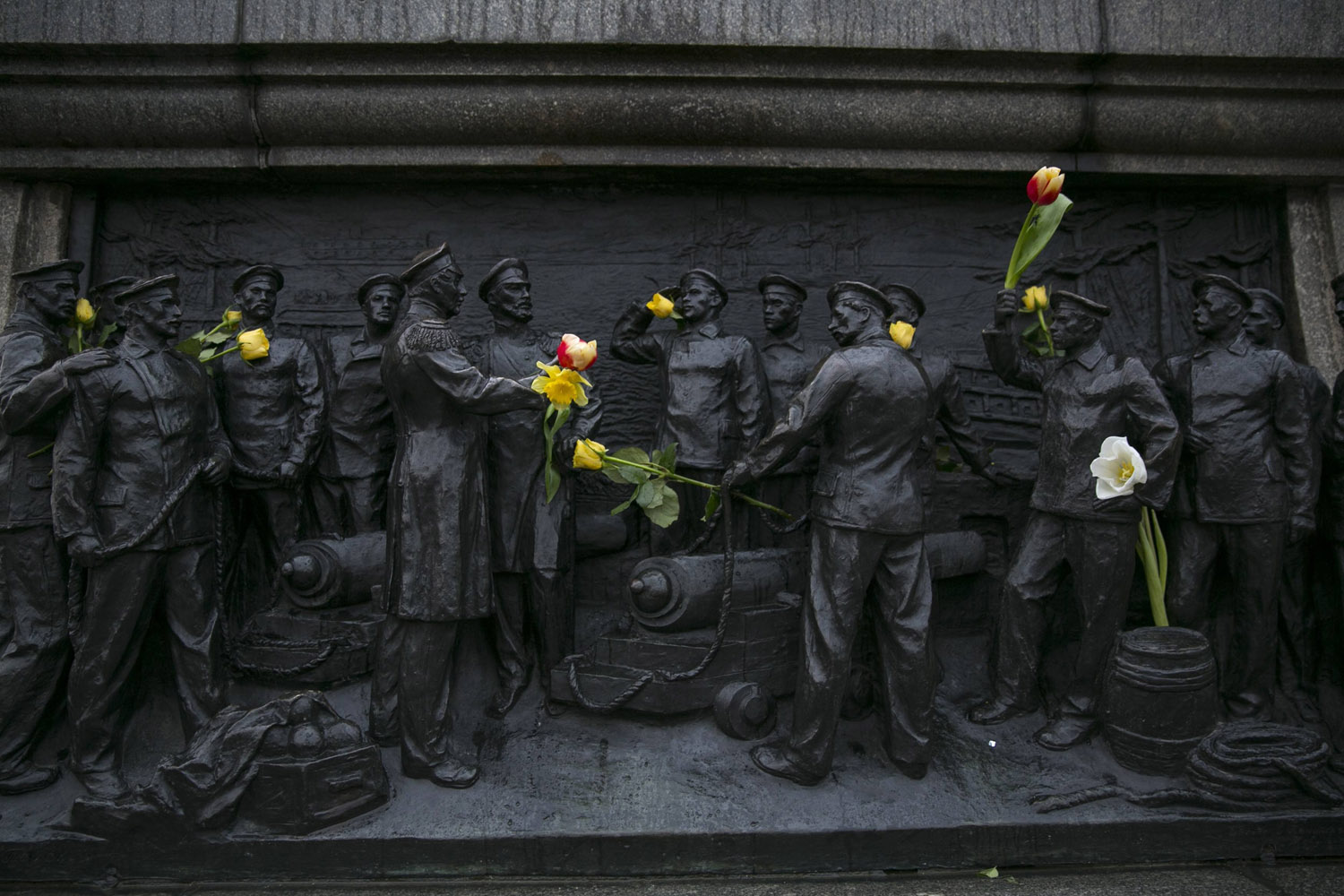 Flowers are placed on a Russian navy monument during a pro-Russia rally in the Crimean port city of Sevastopol