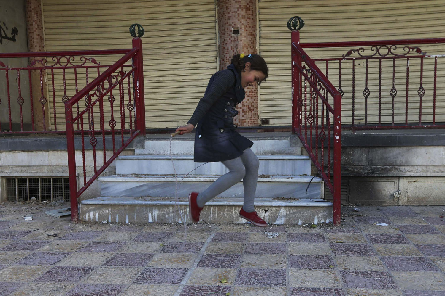 A girl jumps rope in the Duma neighbourhood of Damascus