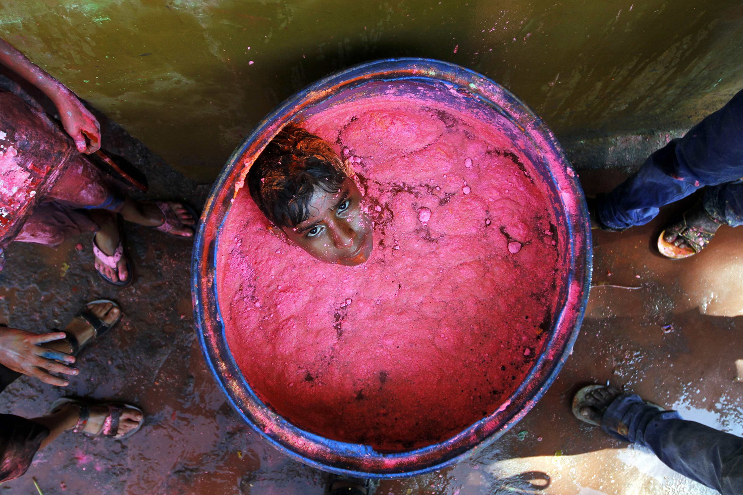 Mar. 16, 2014. A boy sits in a plastic container filled with colored water during Holi celebrations in the southern Indian city of Chennai. Holi, also known as the Festival of Colors, heralds the beginning of spring and is celebrated all over India.