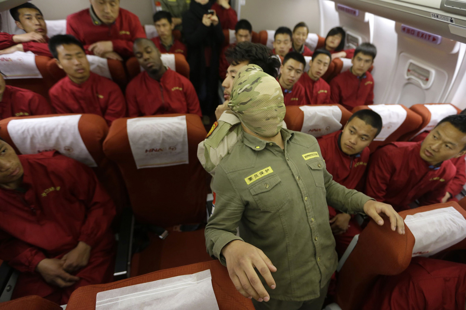 Mar. 18, 2014.Trainees watch a demonstration of close-quarter combat skills at a special course on flight safety inspired by the missing Malaysia Airlines Flight MH370.