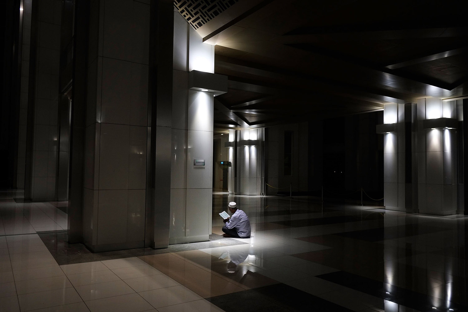 Mar. 18, 2014.  A man recites the Koran after special prayers held for the missing Malaysian airliner MH370 in Kuala Lumpur, Malaysia.