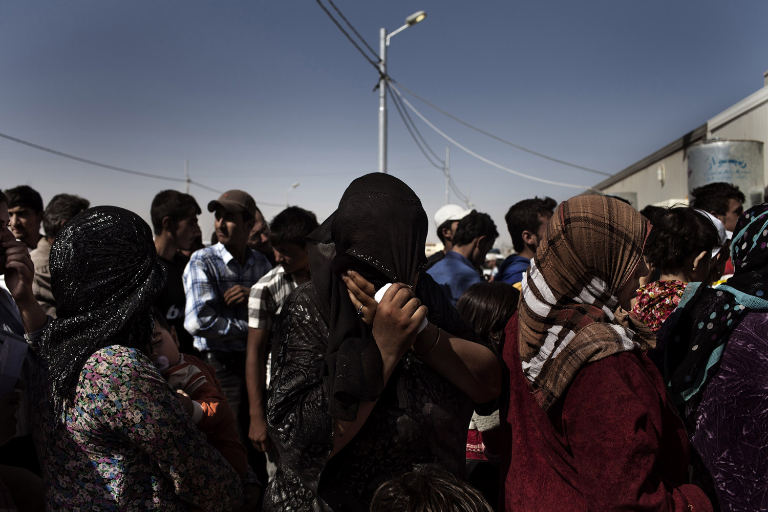 Kurdish-Syrian refugees waiting in the queue for registration at the refugee camp of Kawergosk near Erbil, Iraq.