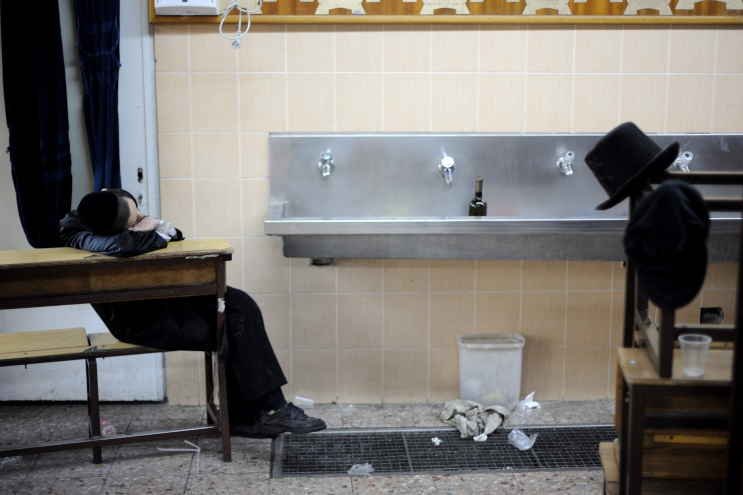 Mar. 17, 2014. An Ultra-Orthodox Jew rests during celebrations of Purim in the Mea Shearim neighborhood in Jerusalem.