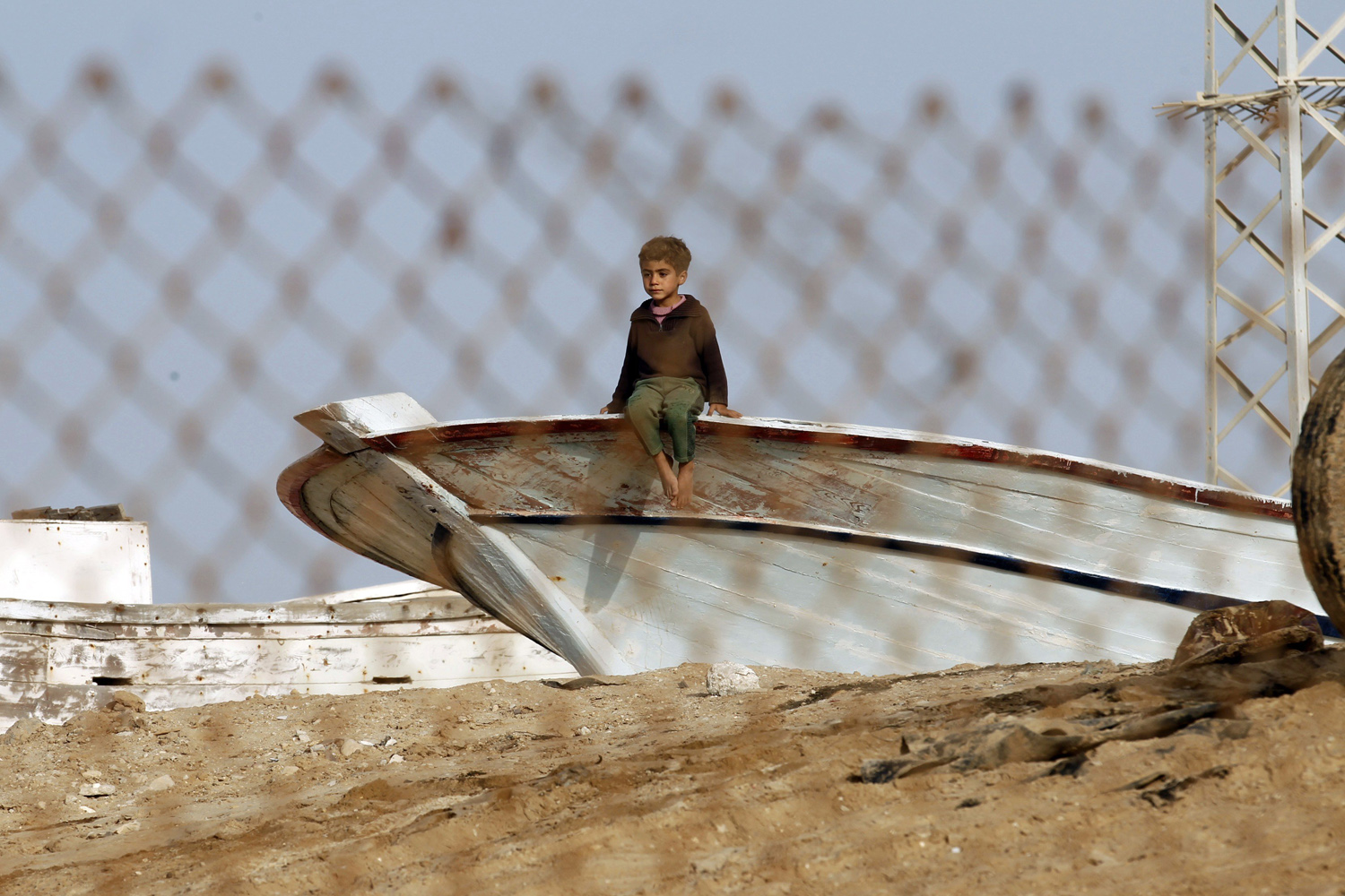 Mar. 7, 2014. A Palestinian boy sits on a boat on the seashore as he watches a demonstration against the siege on the impoverished Hamas-run Gaza Strip in the coastal town of Rafah.