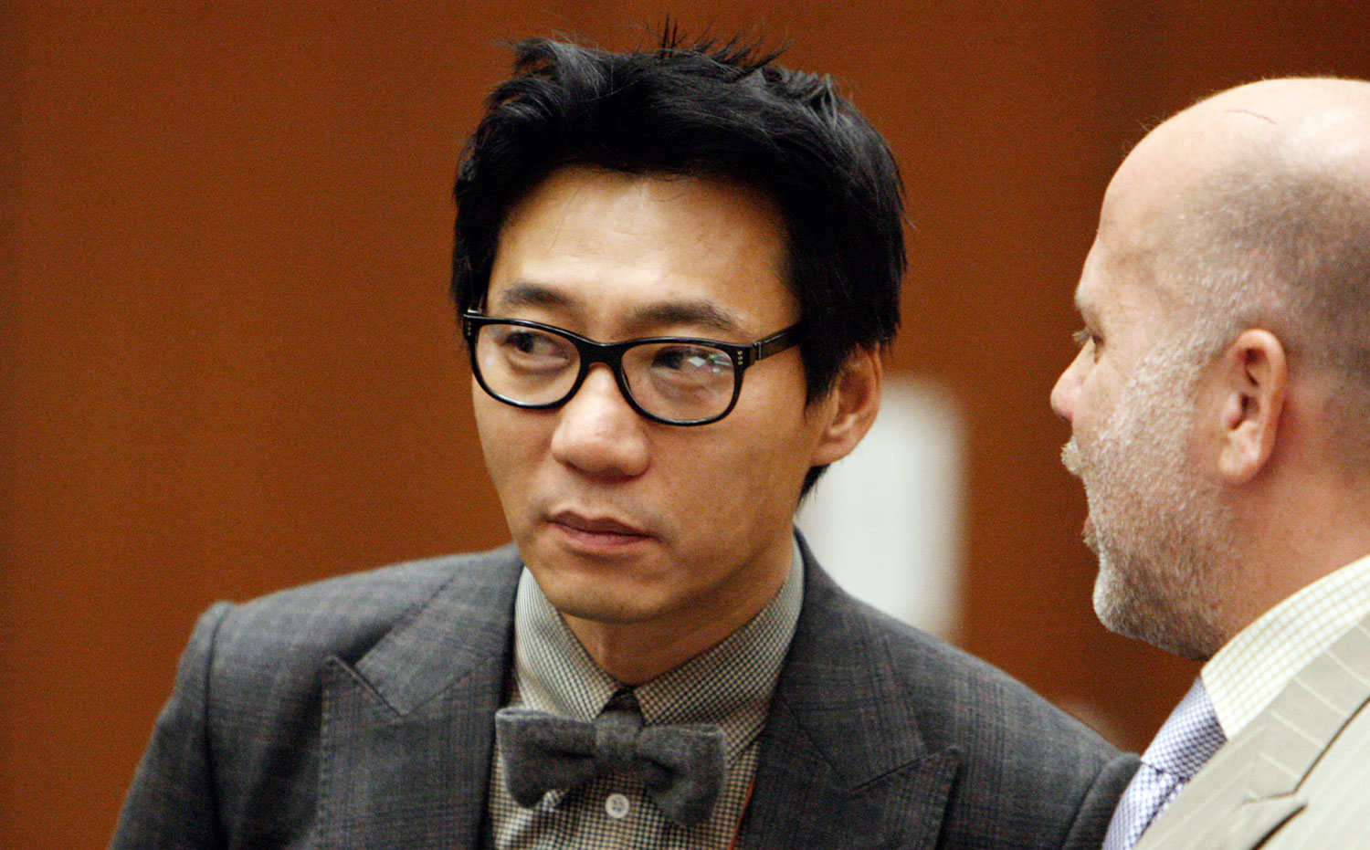 Young Lee stands with his attorney Philip Kent Cohen, right, during his arraignment in the Los Angeles Criminal Courts Building in Los Angeles in 2012. (AP)