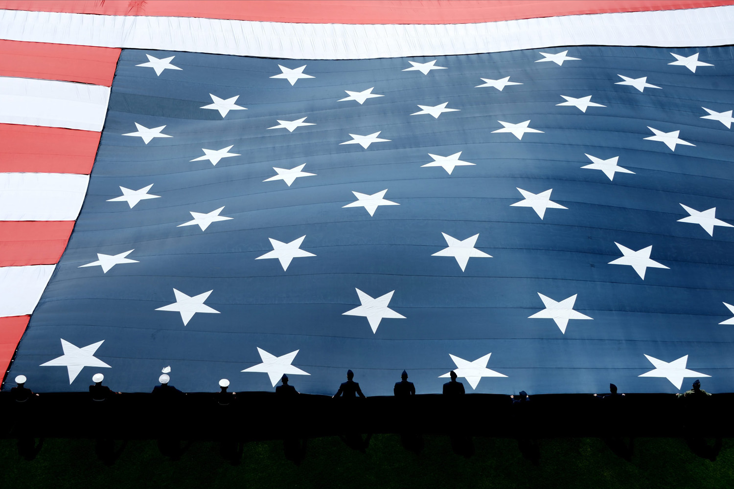 Mar. 31, 2014. A giant American flag is unfurled on the field during ceremonies before the start of the game between the Washington Nationals and the New York Mets at Citi Field in Flushing Meadows, New York. (Justin Lane—EPA)