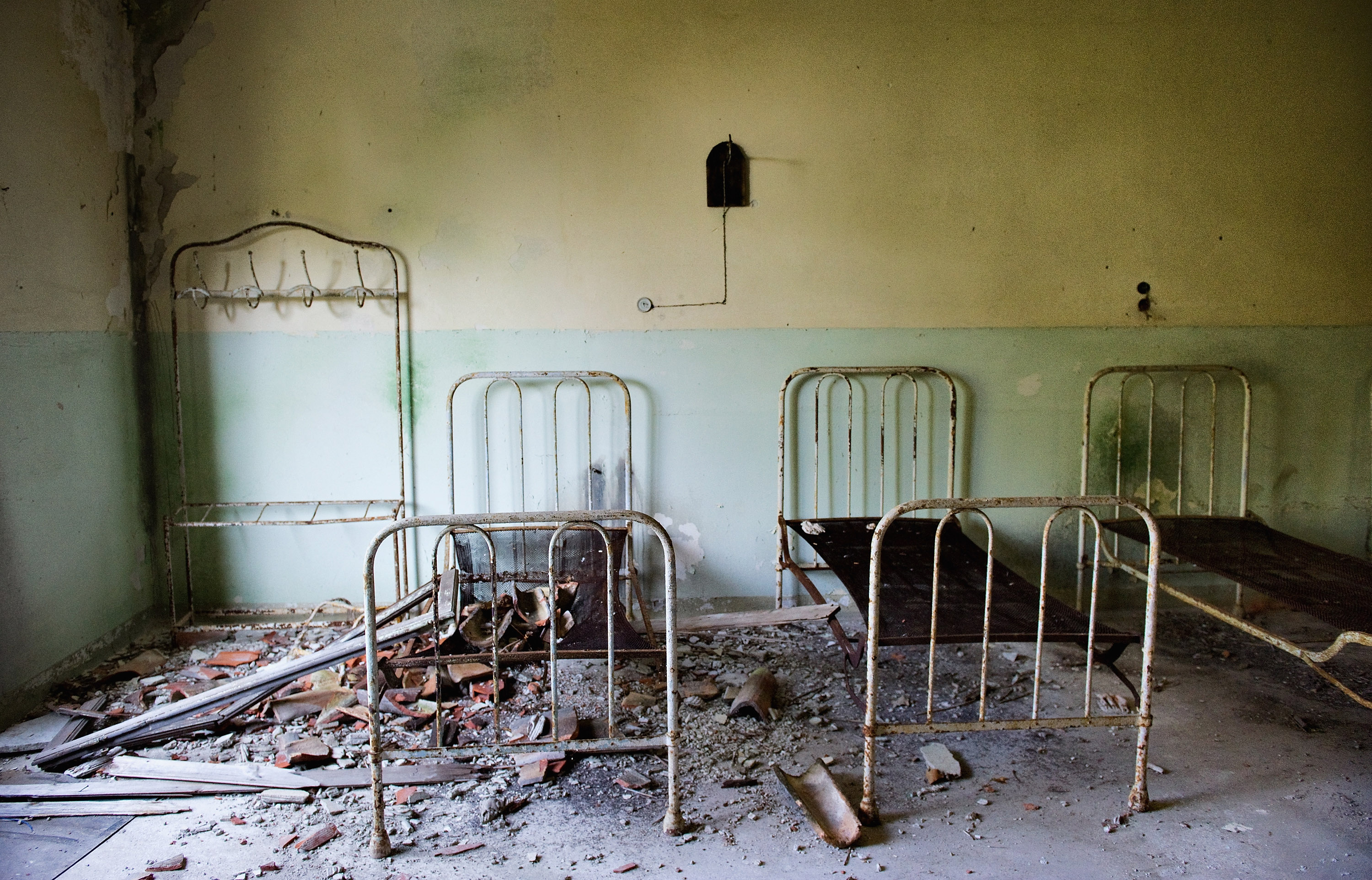 VENICE, ITALY - AUGUST 27:   Beds and furniture remain in one of the dormitories in the psychiatric ward of the abandoned Hospital of Poveglia on August 27, 2011 in Venice, Italy. The island of Poveglia, with its ruined hospital and plague burial grounds, is said to be the most haunted location in the world. The area is located within a multi-million dollar piece of real estate but is deserted and off limits to the public. The dark and derelict forbidding shores are only minutes away from the glamour of the Venice Film Festival on the Lido.  (Photo by Marco Secchi/Getty Images) (Marco Secchi—Getty Images)