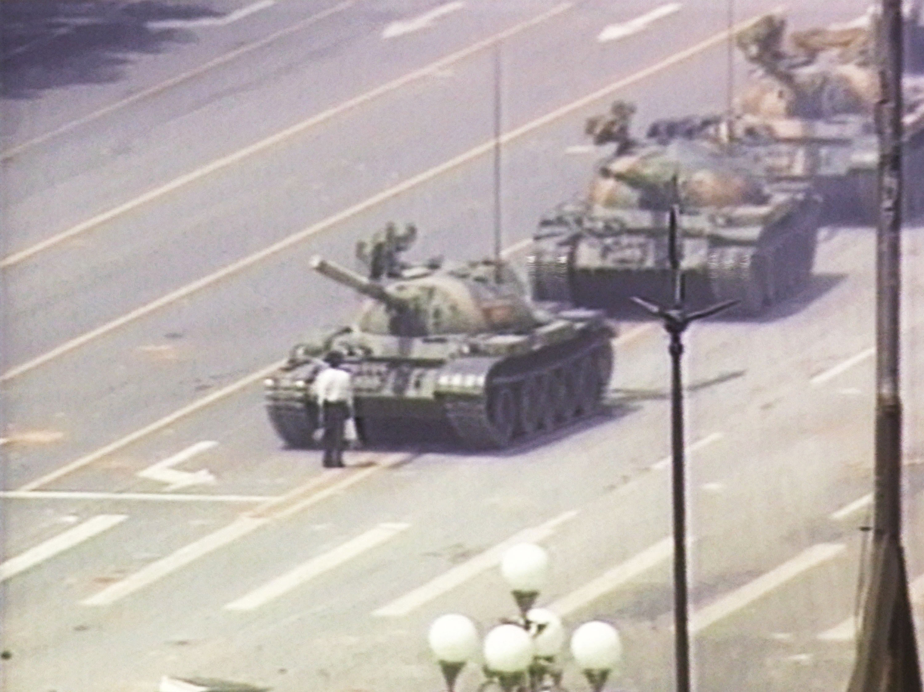 A lone demonstrator stands down a column of tanks June 5, 1989, at the entrance to Tiananmen Square in Beijing. The incident took place on the morning after Chinese troops fired on pro-democracy students who had been protesting in the square since April 15, 1989 (CNN—Getty Images)