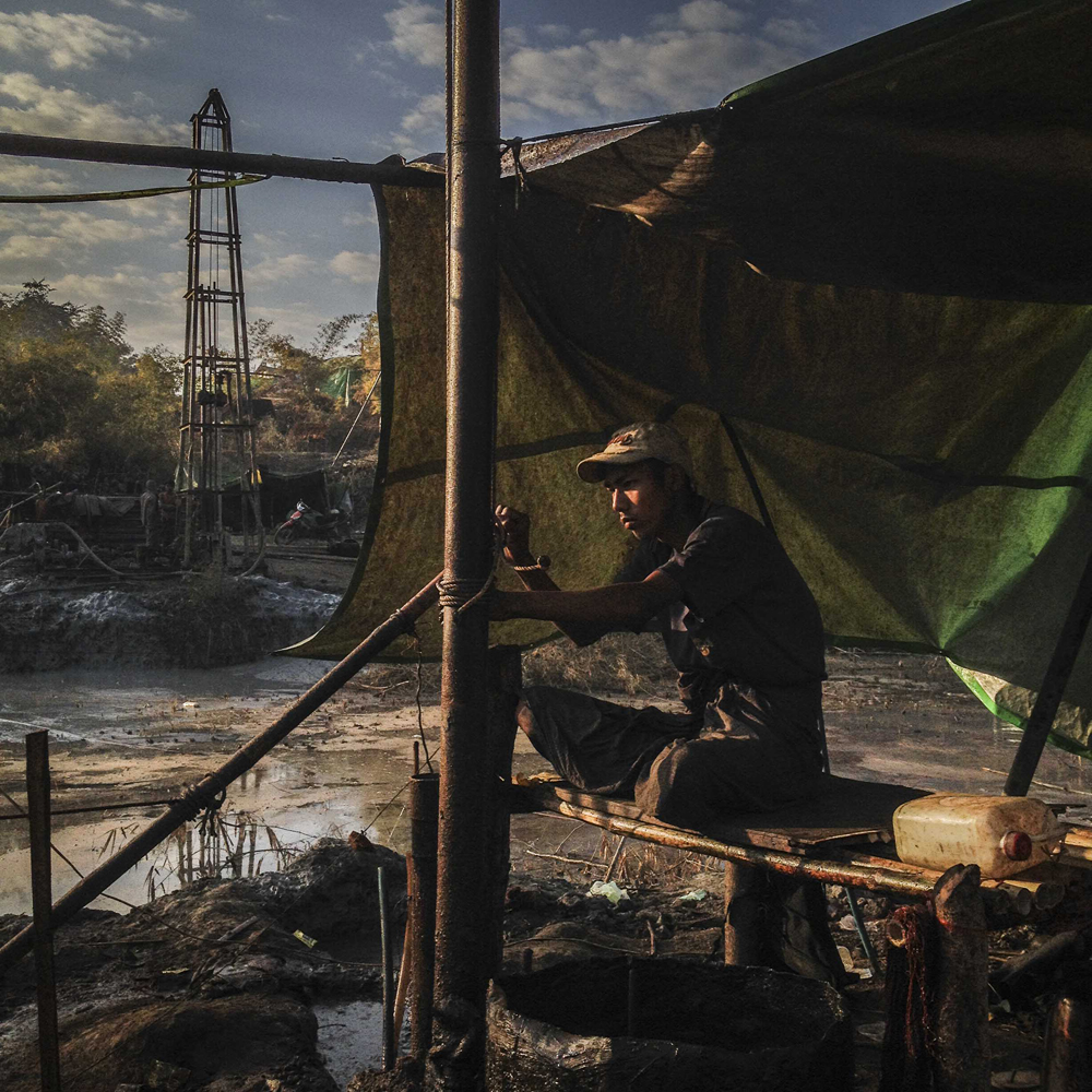 A freelance oil miner pumps for oil in the town of Thayet, located in central Myanmar on January 16, 2014.