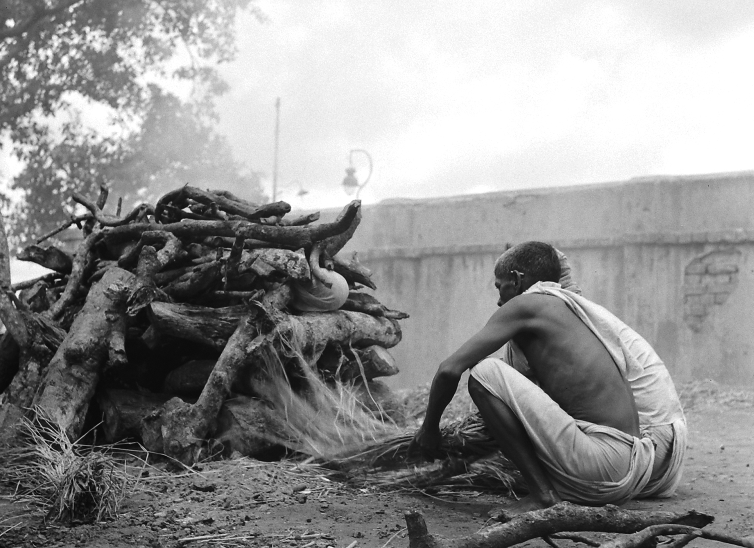 Aftermath of August 1946 Calcutta religious riots; tending a pyre for the dead.