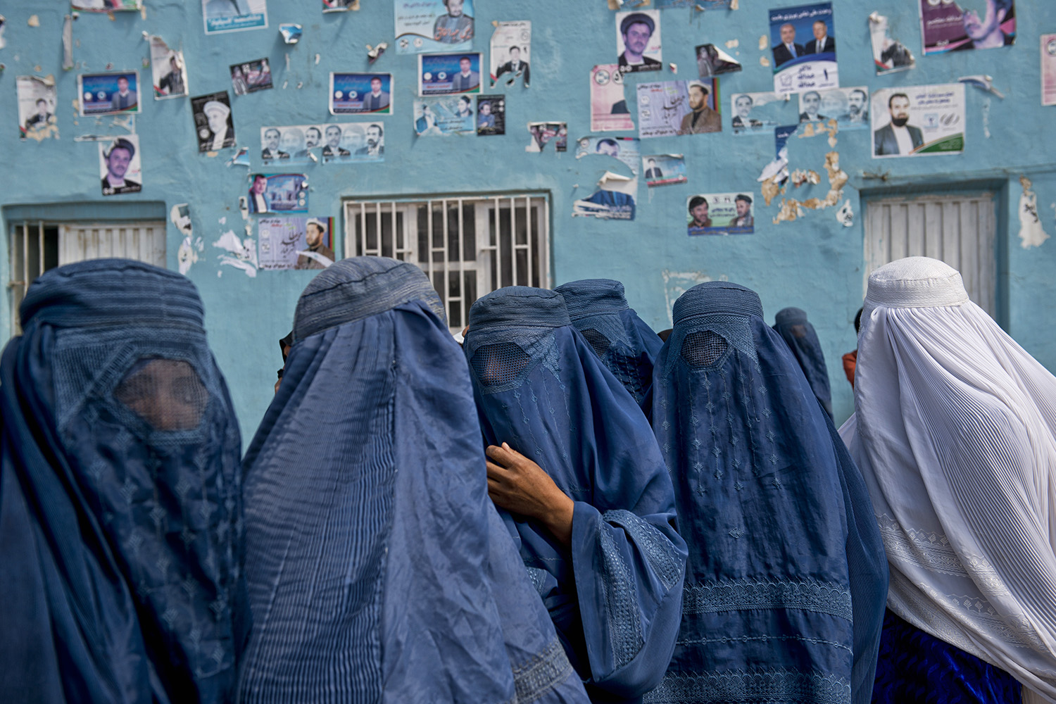 Afghan women leave an election rally at a stadium in Mazar-i-Sharif, Afghanistan, March 27, 2014.
