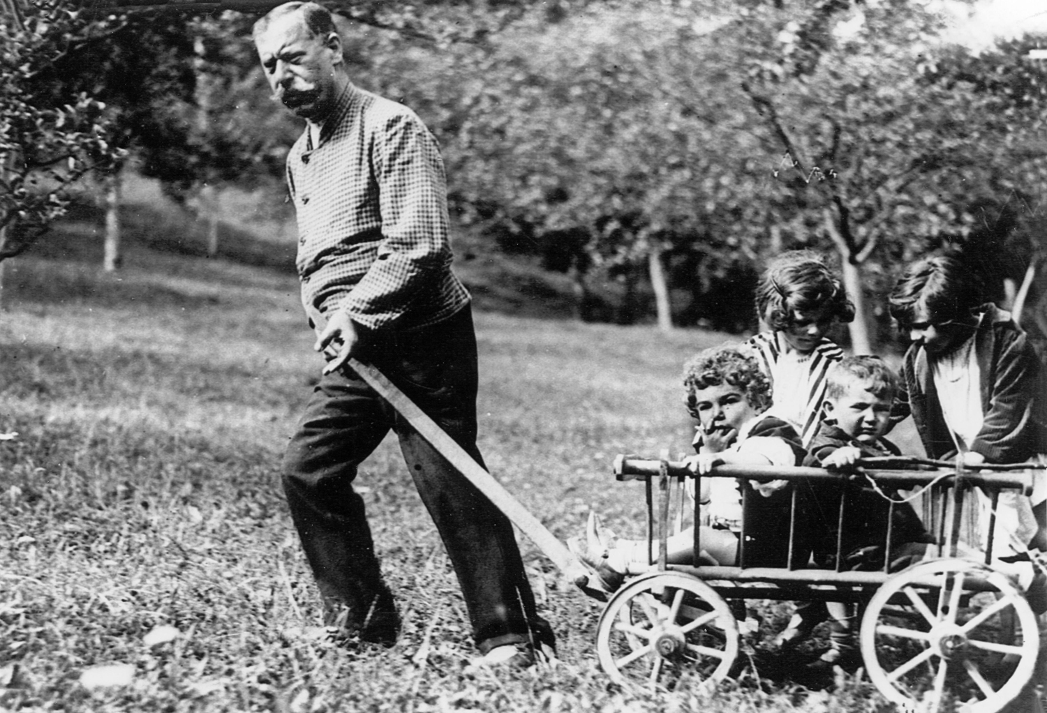 Robert Braun, one of the children saved by the Krauses, sits between his sisters Martha and Johanna, while being pulled in a wagon by their father, Max.